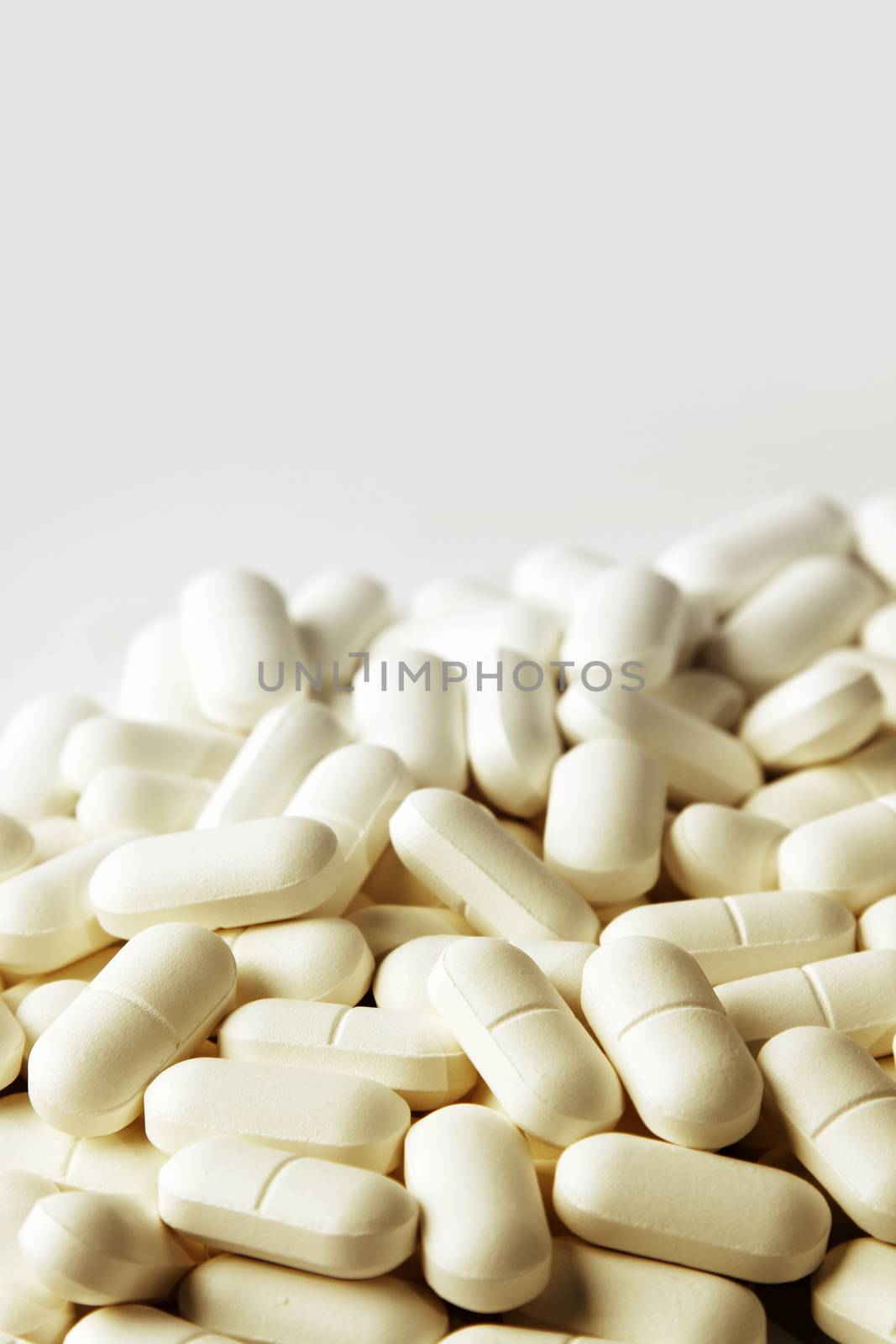 Pile of pills on plain background