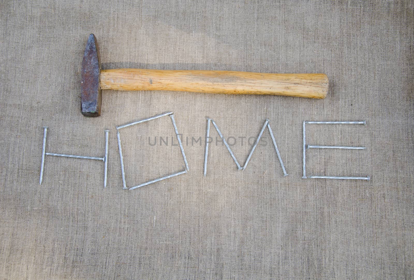 work hammer and stylized inscription of nails on linen texture