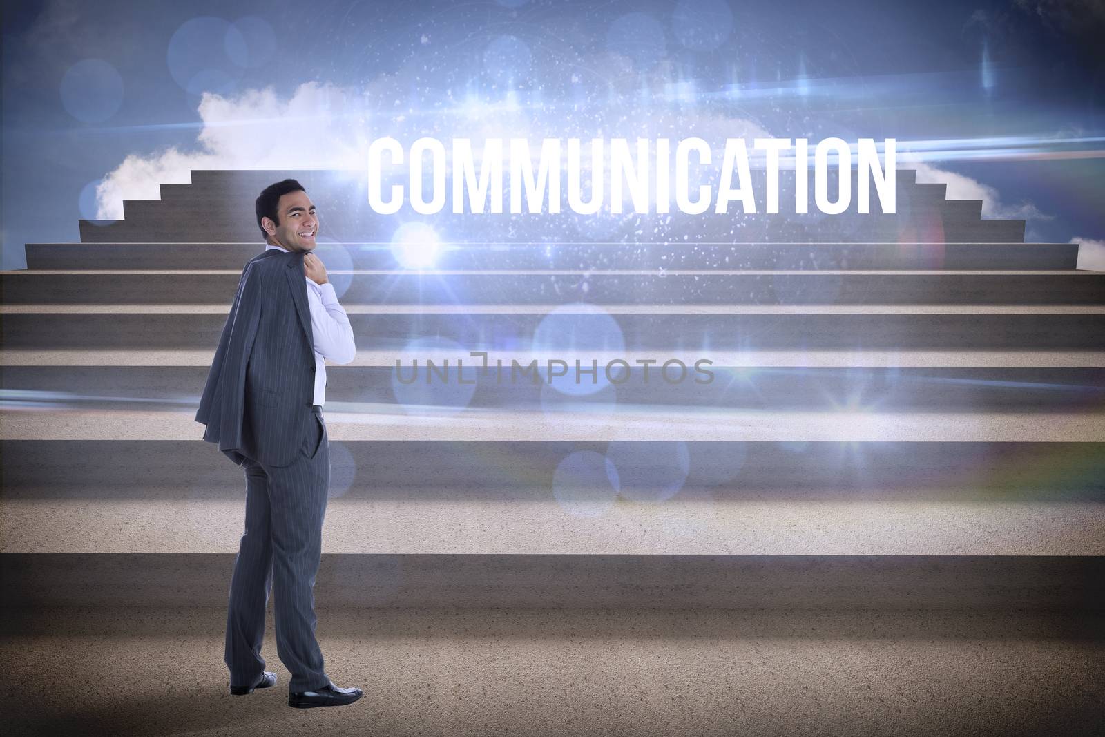 The word communication and smiling businessman standing against steps against blue sky