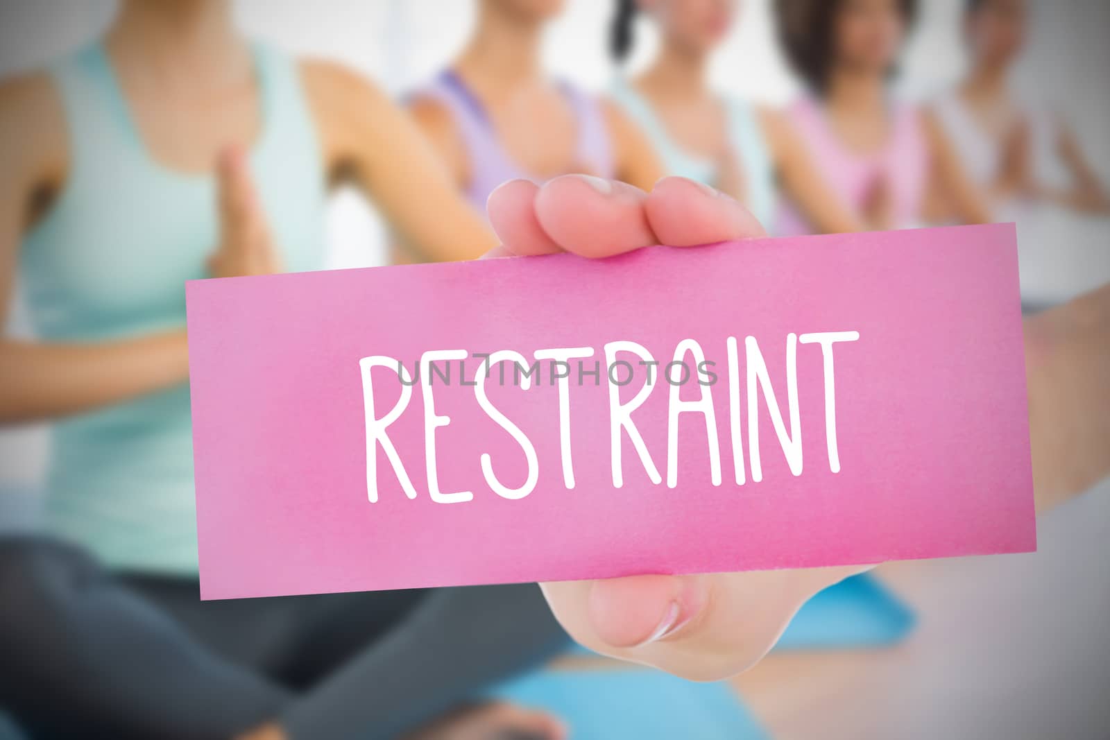 Woman holding pink card saying restraint against fitness class in gym