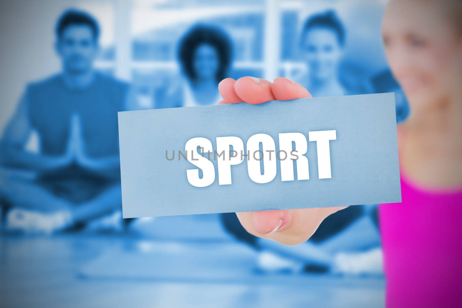 Fit blonde holding card saying sport against yoga class in gym 