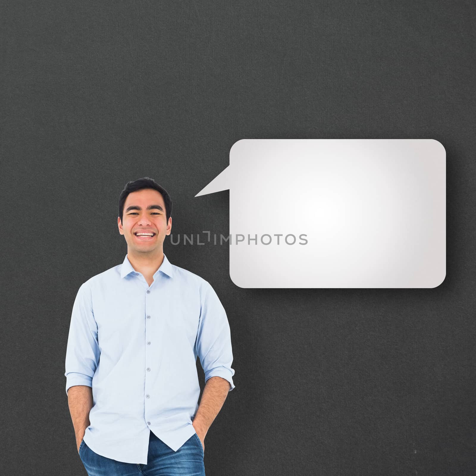 Smiling casual man standing against speech bubble