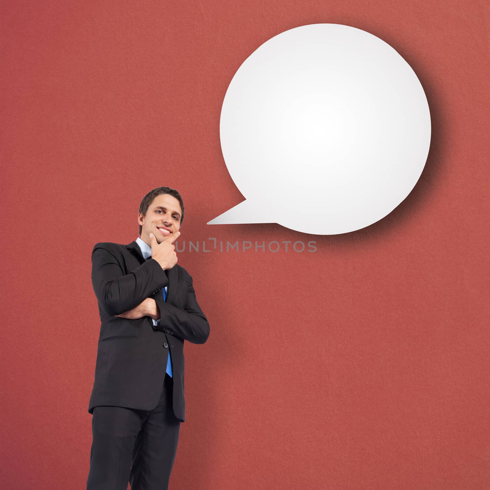 Thinking businessman touching chin against speech bubble