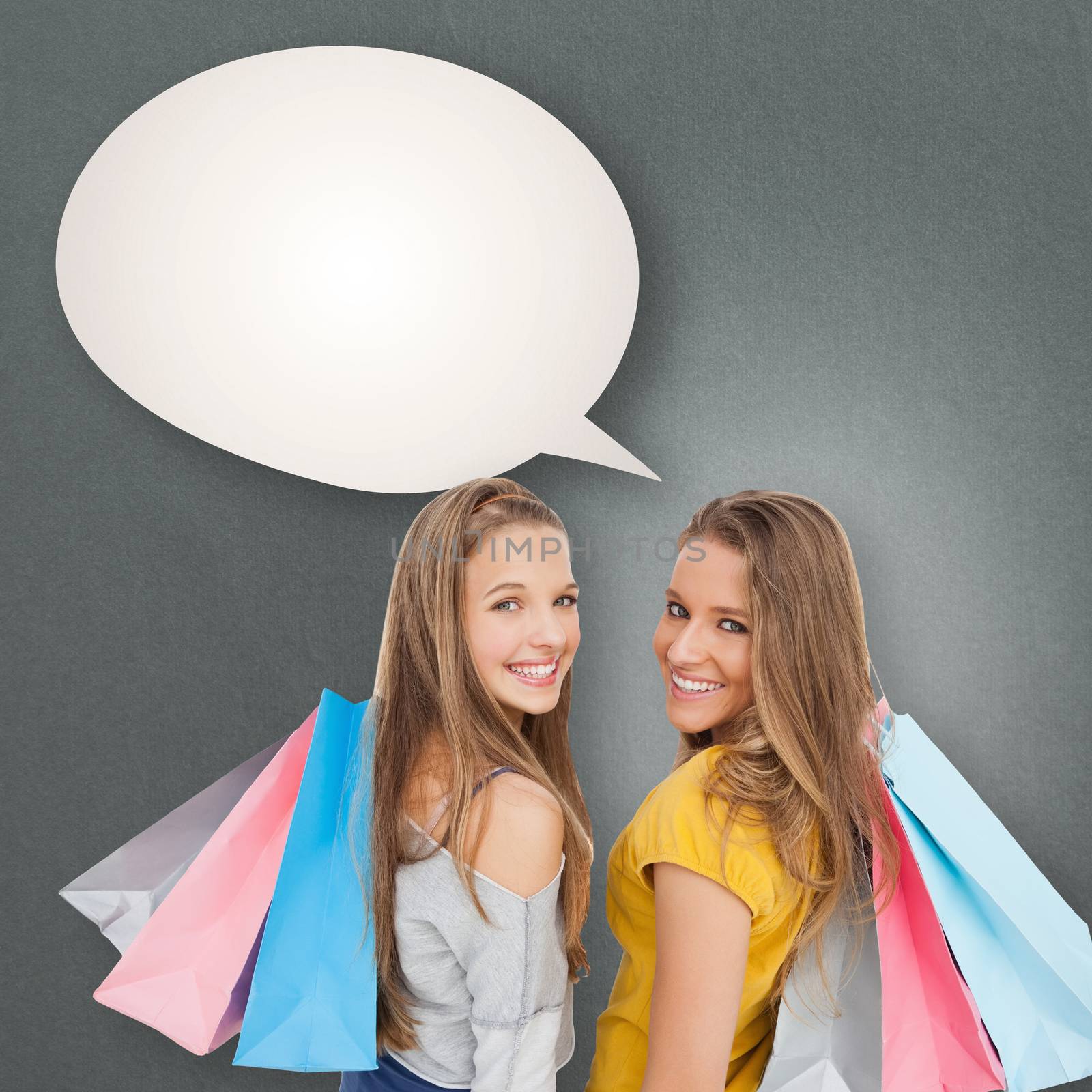 Two young women with shopping bags against speech bubble