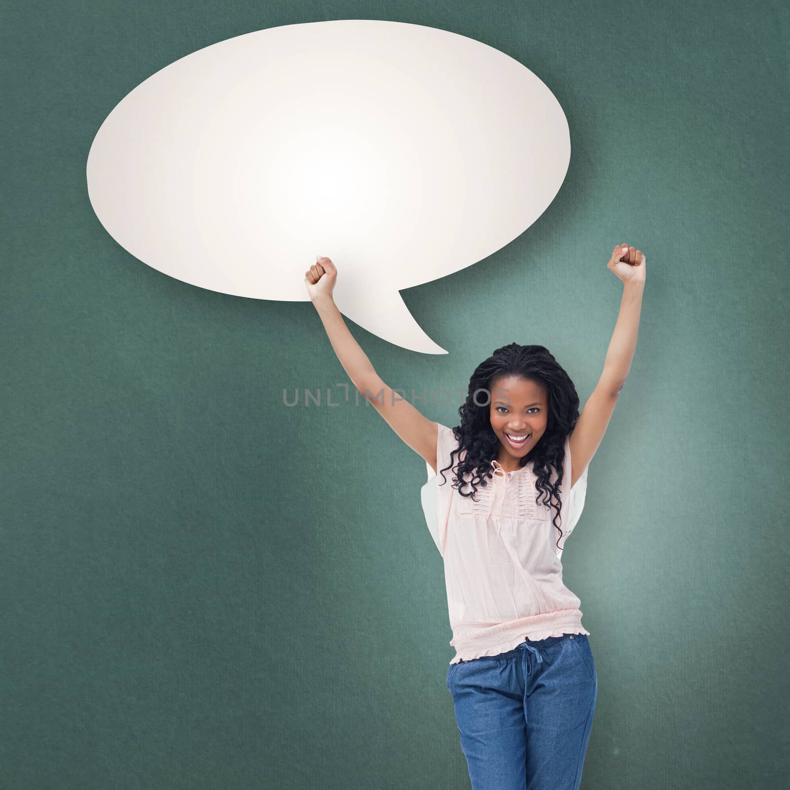 A young happy woman stands with her hands in the air against speech bubble
