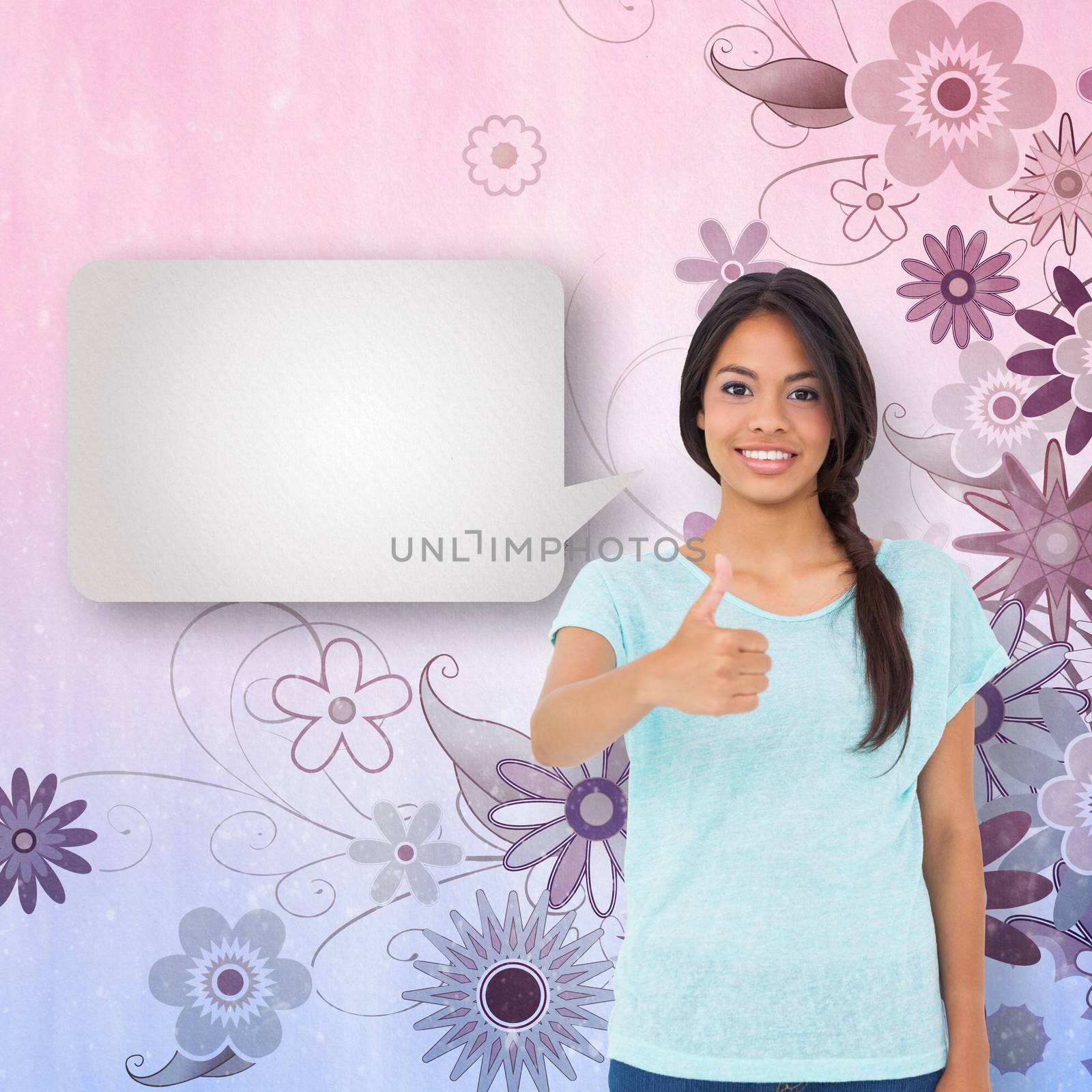 Happy brunette with speech bubble giving thumbs up against digitally generated girly floral design