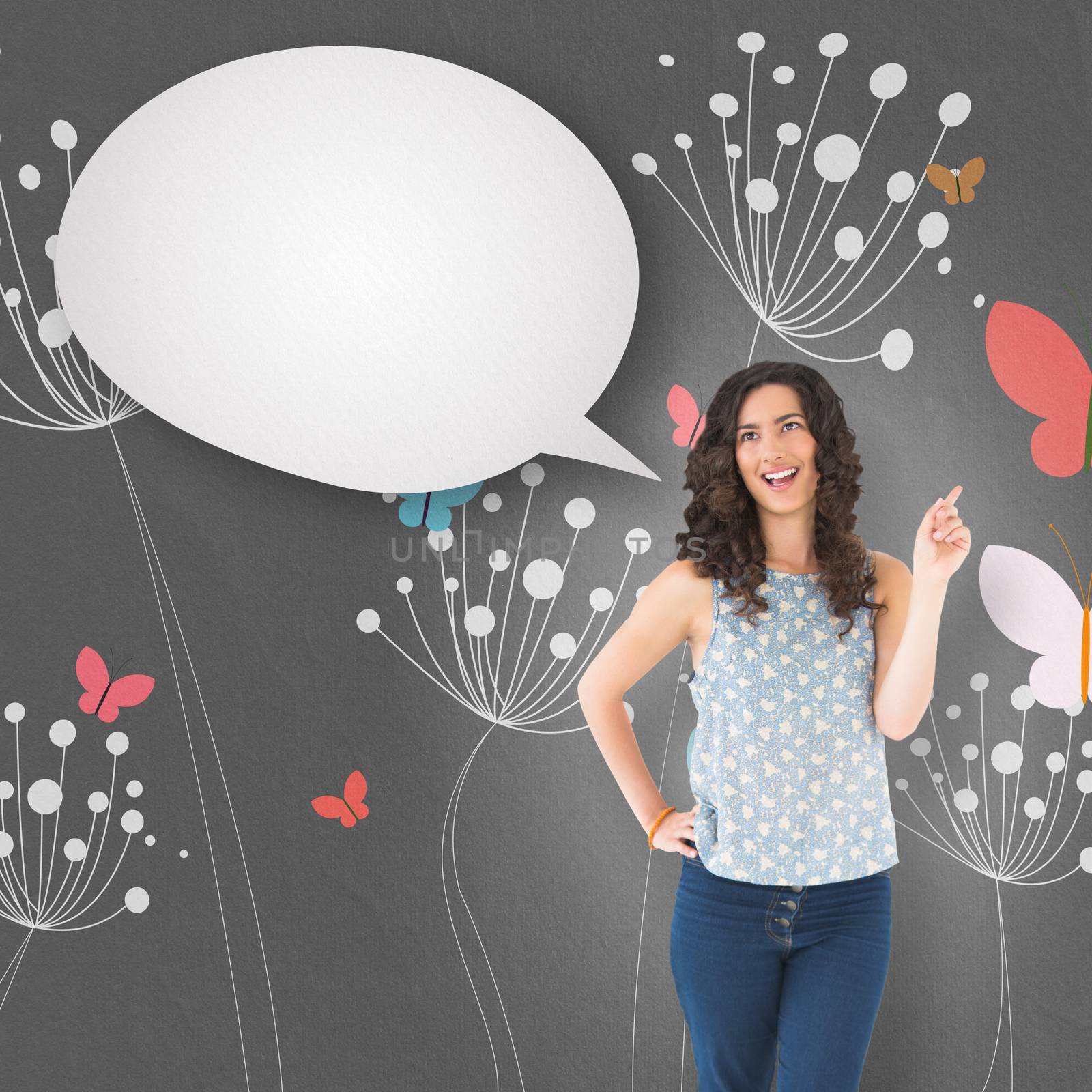 Happy beautiful brunette posing with speech bubble against colourful butterflies and dandelions