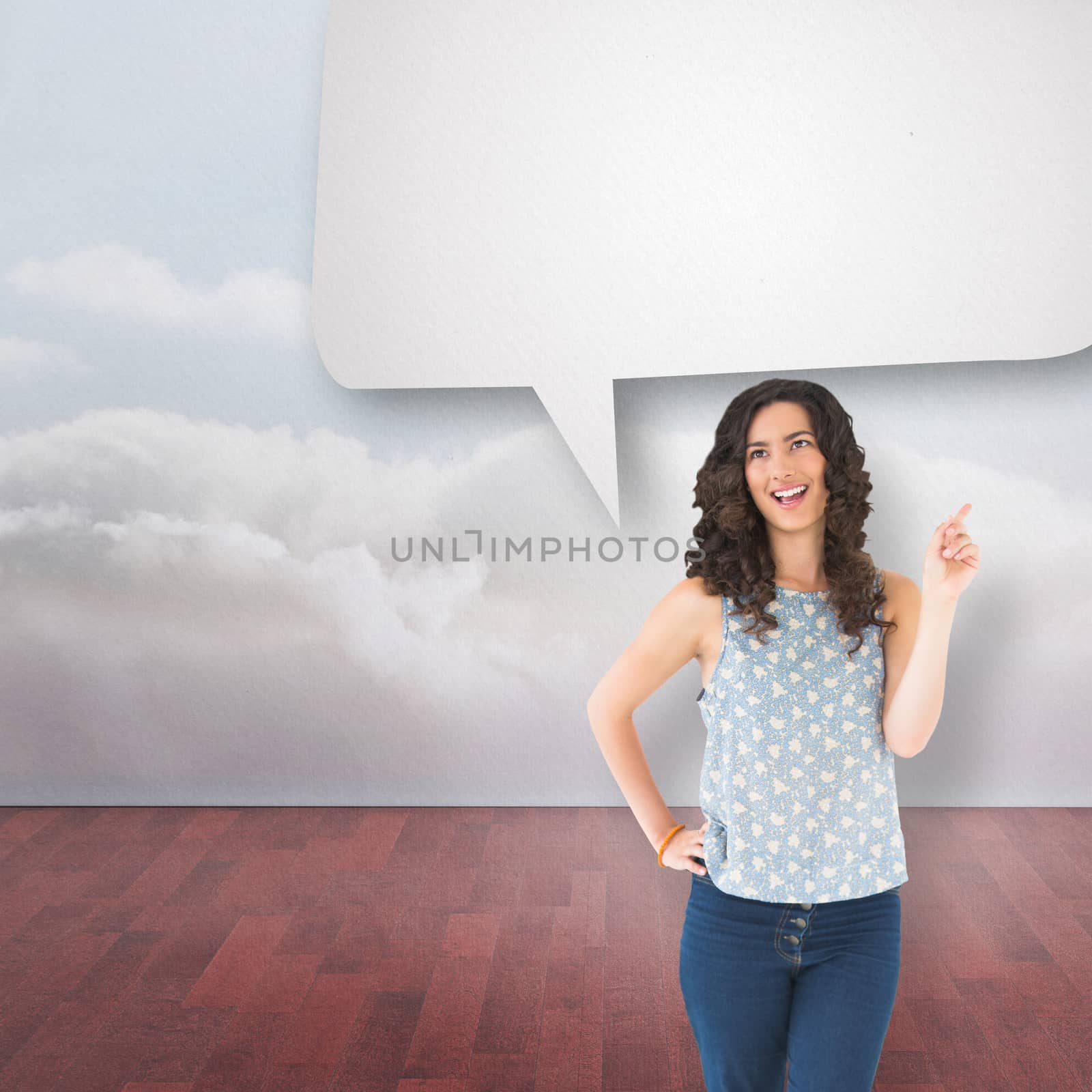 Happy beautiful brunette posing with speech bubble against clouds in a room