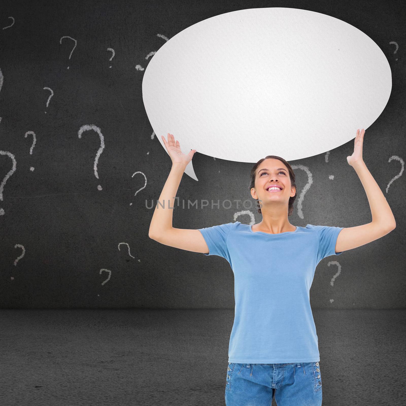 Pretty brunette gesturing against speech bubble in blackboard room