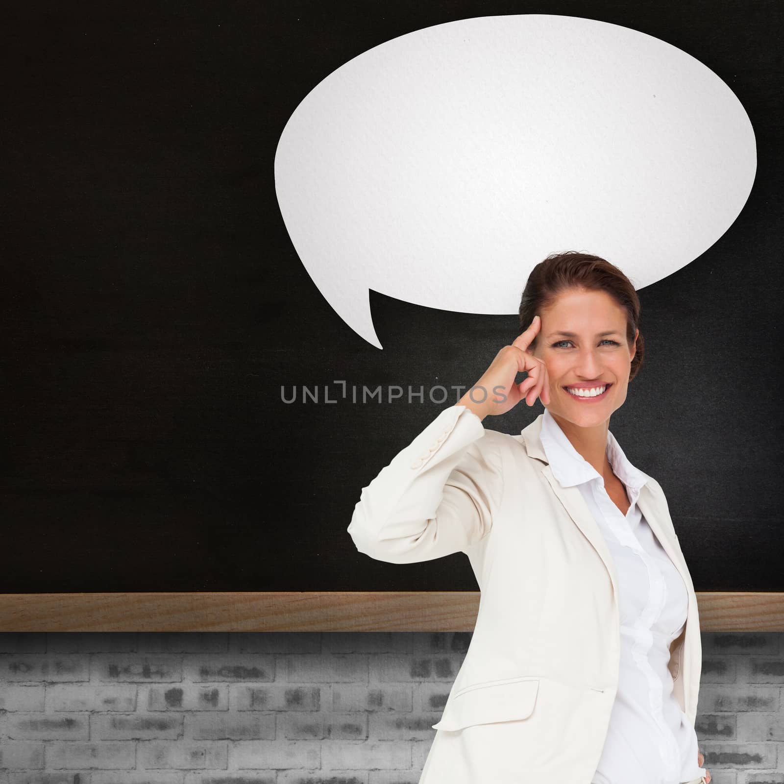 Thinking businesswoman with speech bubble against blackboard on wall