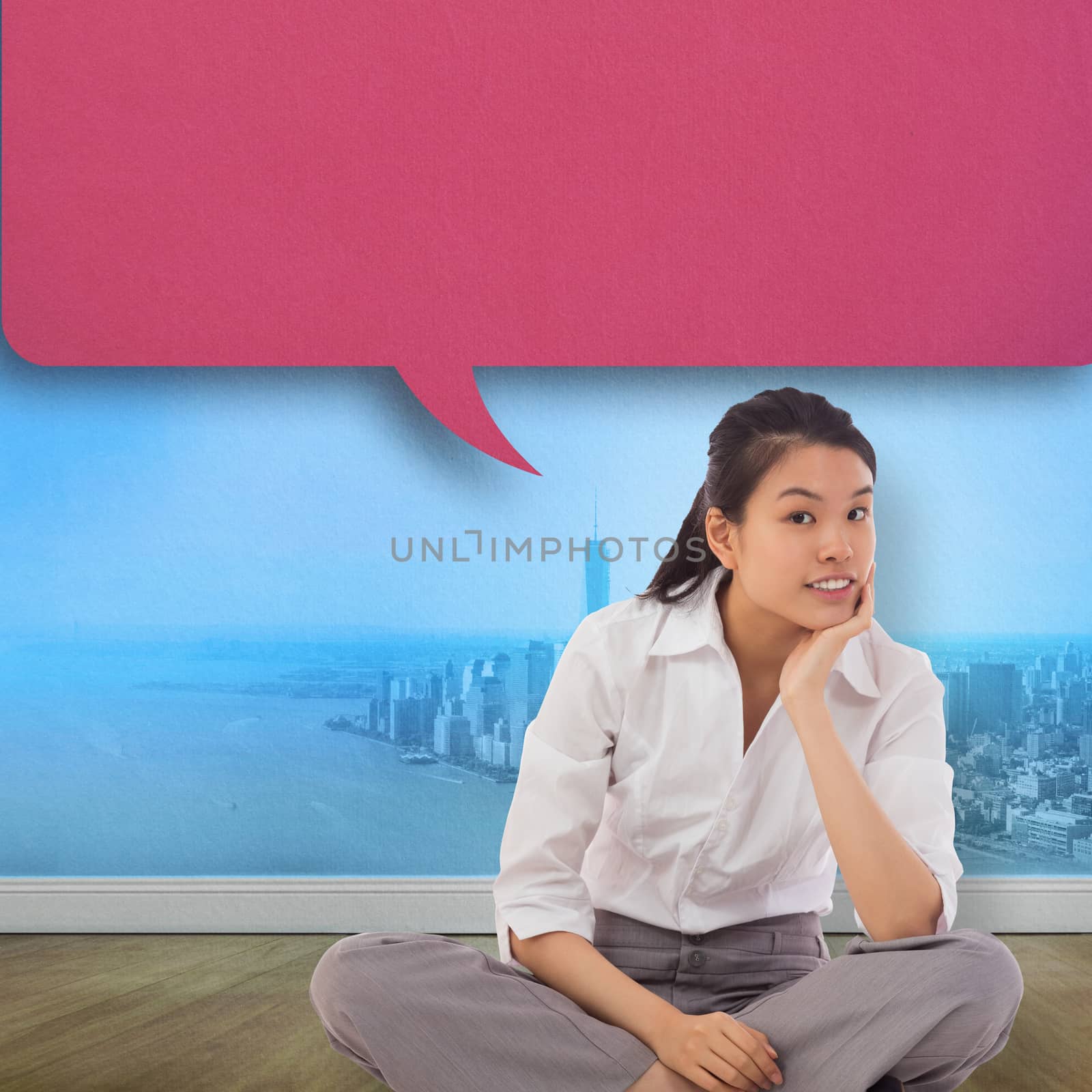 Composite image of businesswoman sitting cross legged thinking with speech bubble by Wavebreakmedia