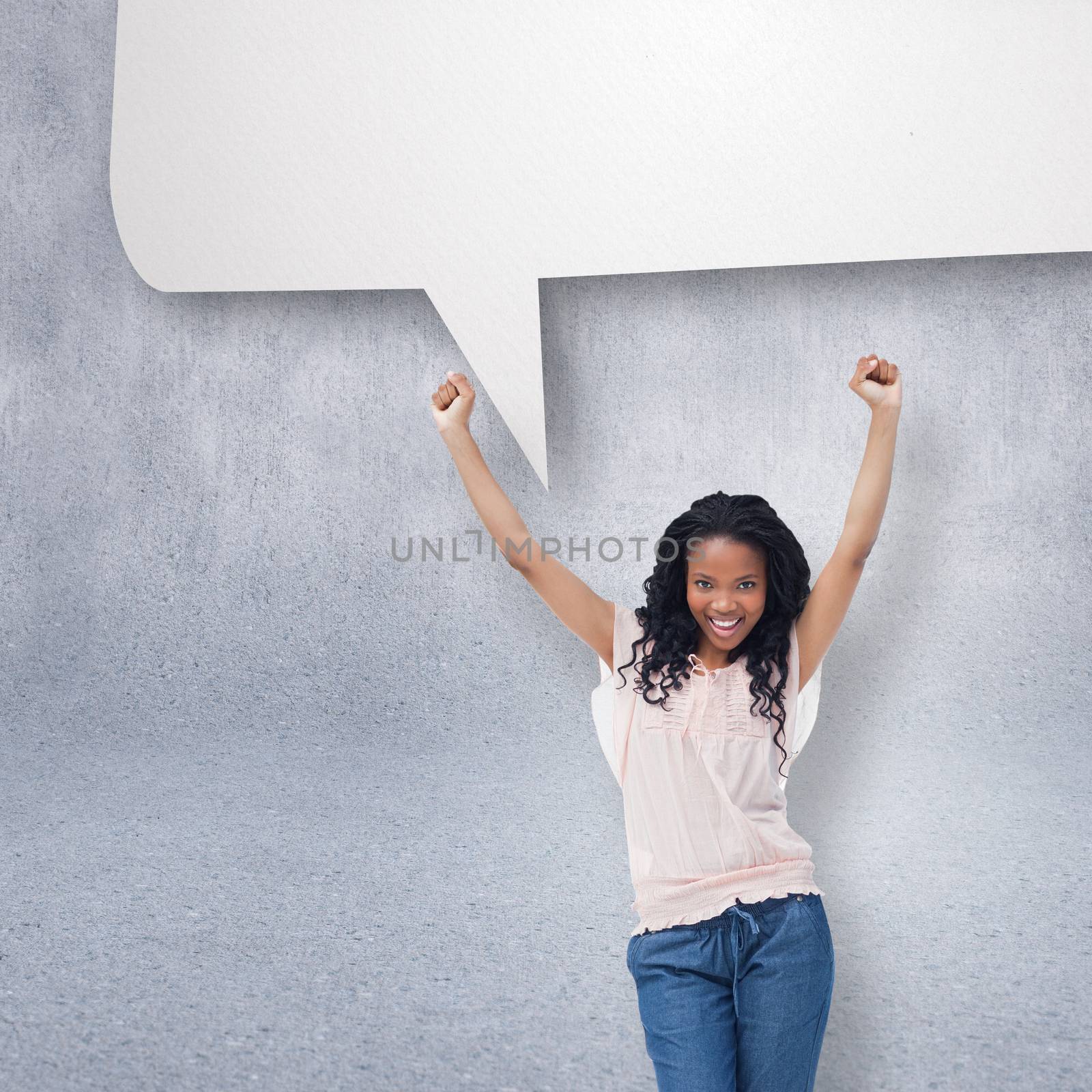 A young happy woman with speech bubble against grey wall