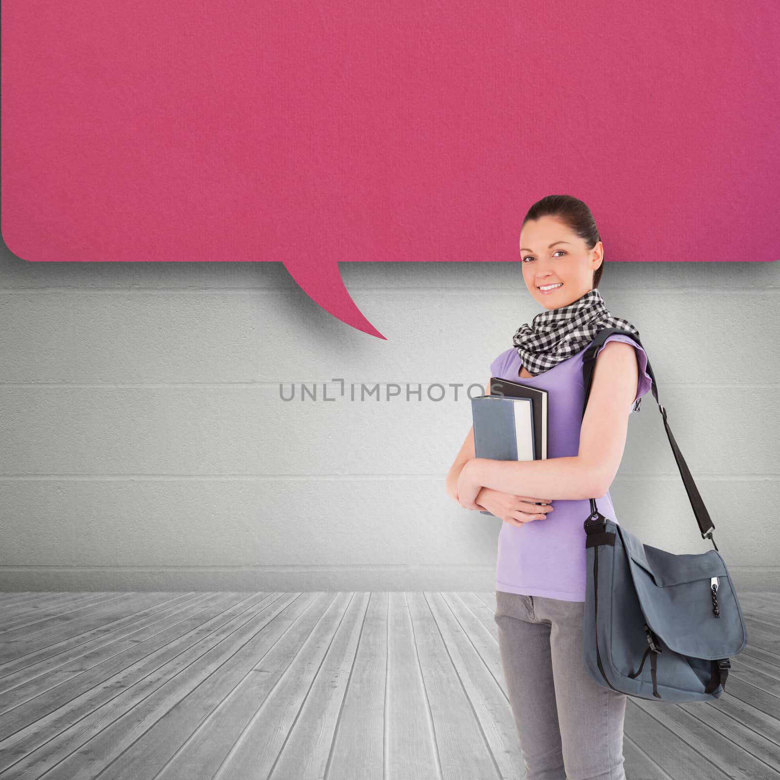 Composite image of attractive student holding books and her bag while standing by Wavebreakmedia