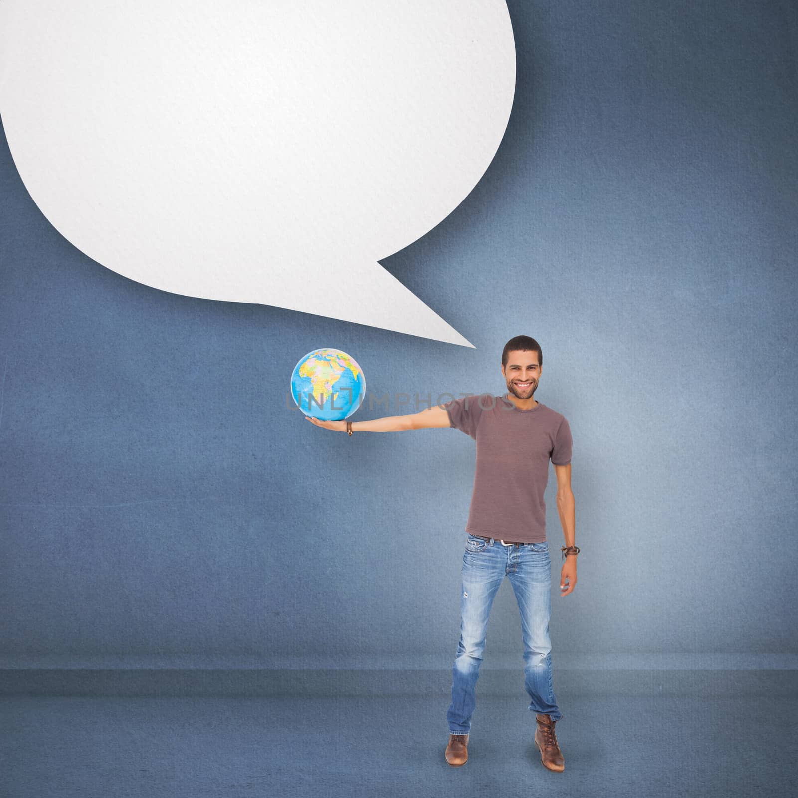 Handsome man holding out a globe against speech bubble