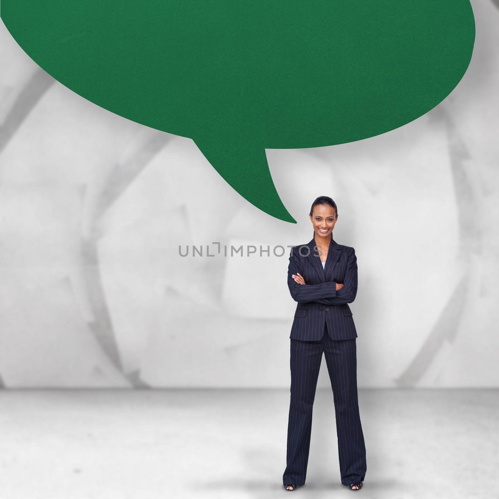 Confident businesswoman smiling at the camera against speech bubble