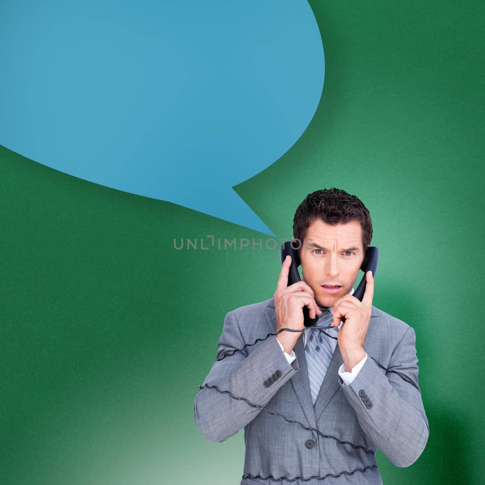 Angry businessman tangles up in phone wires with speech bubble against green vignette