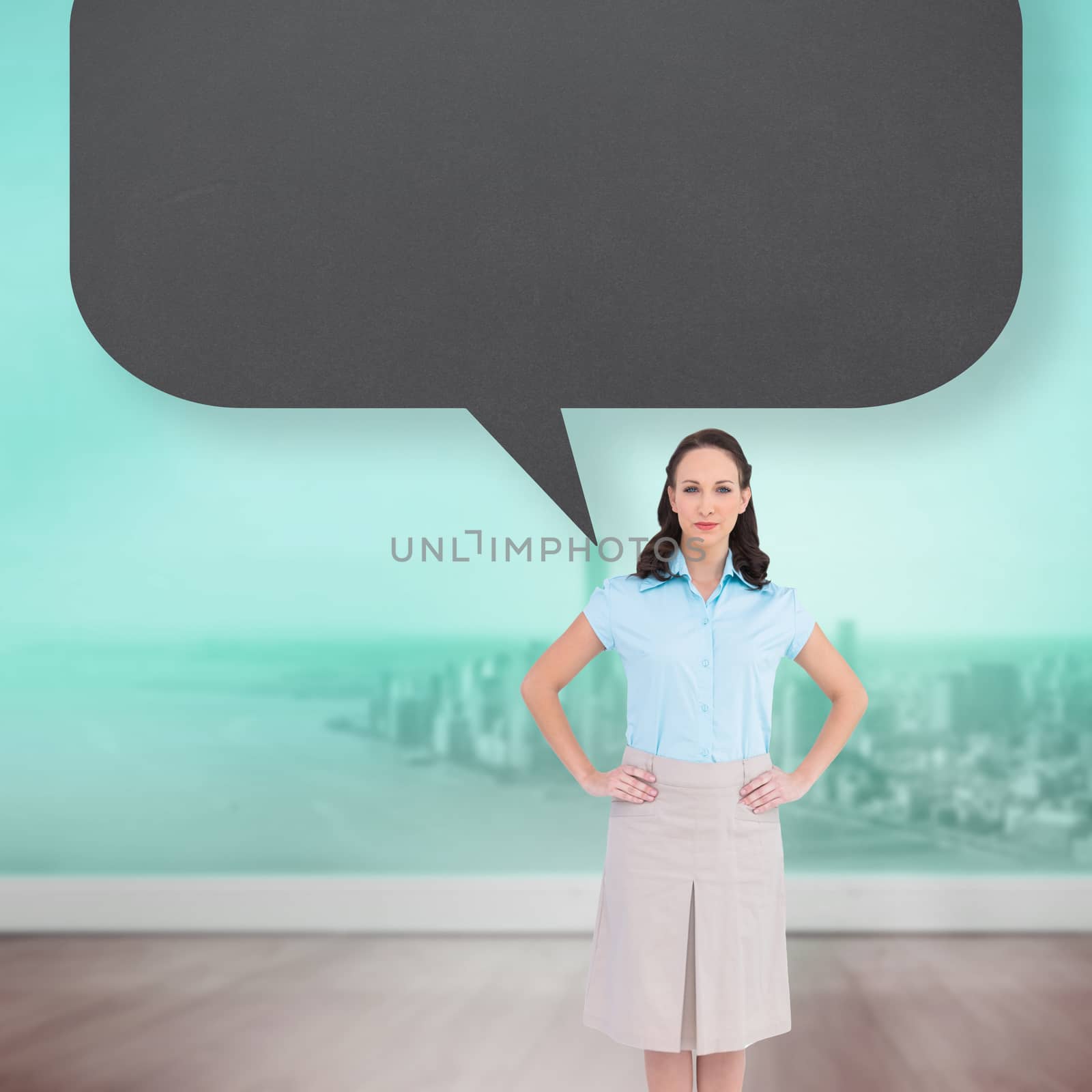 Serious stylish businesswoman posing with speech bubble against city projection on wall