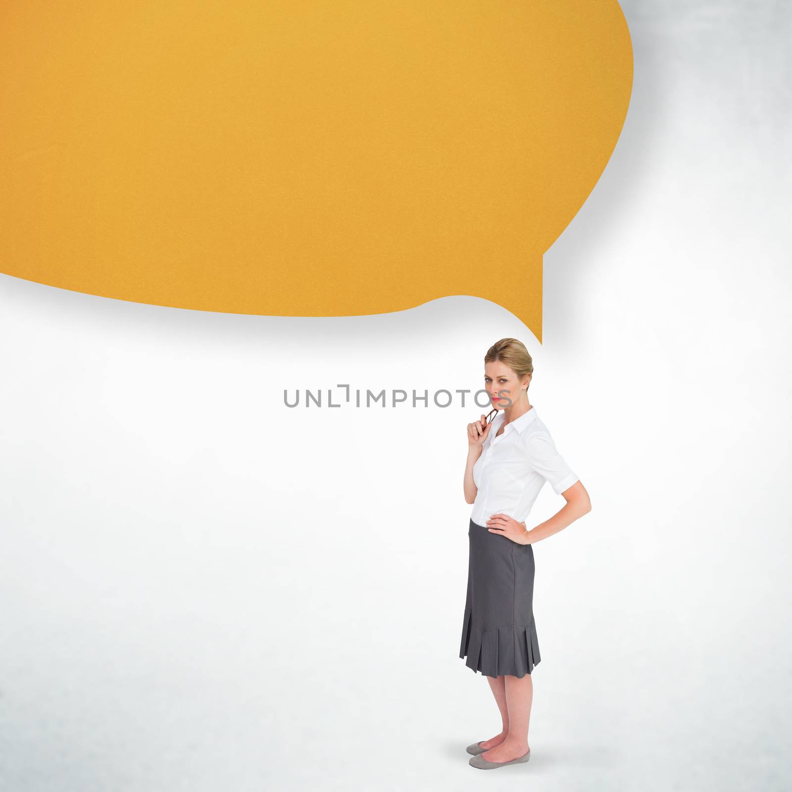 Thinking businesswoman with speech bubble against white wall