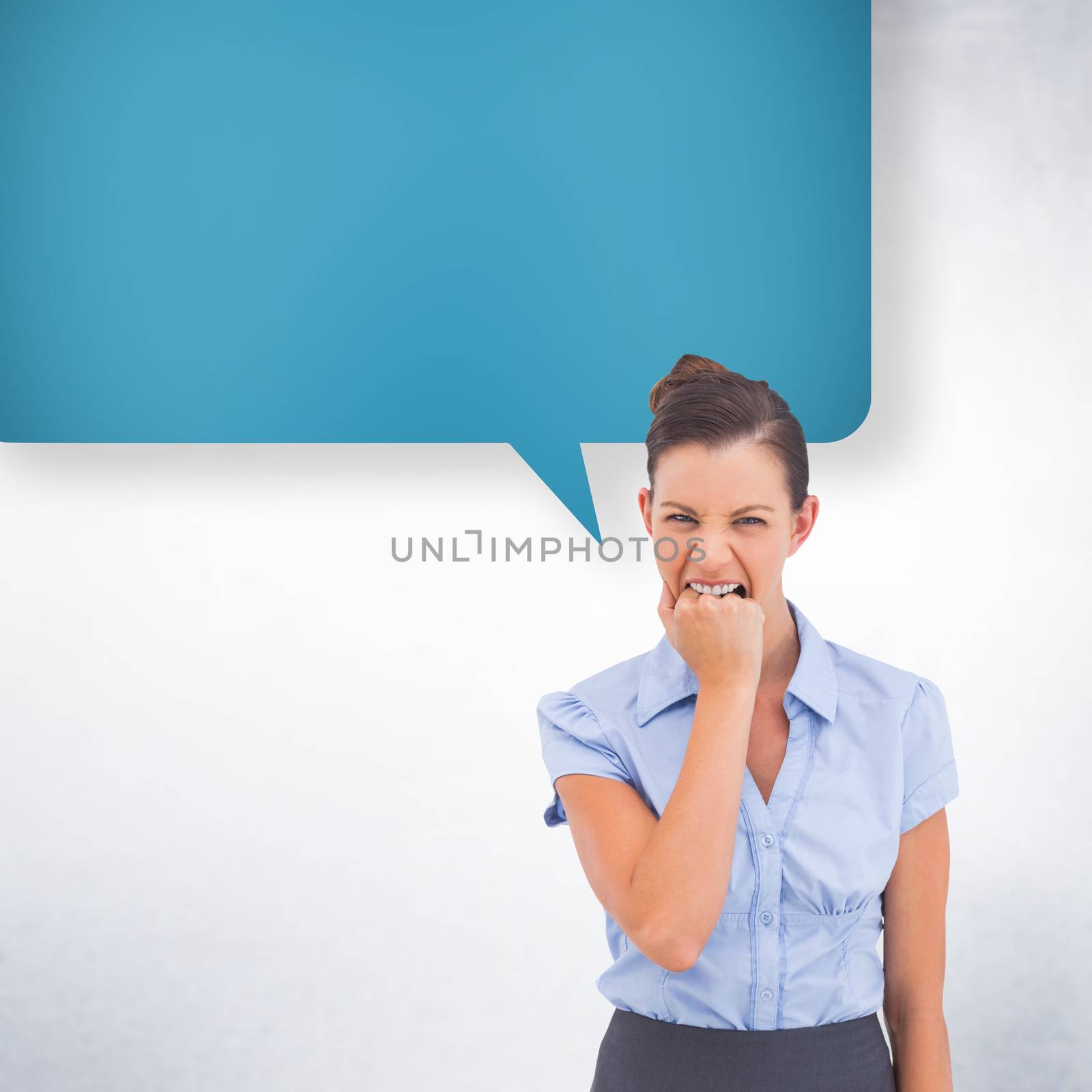 Furious businesswoman with speech bubble looking at the camera against white wall