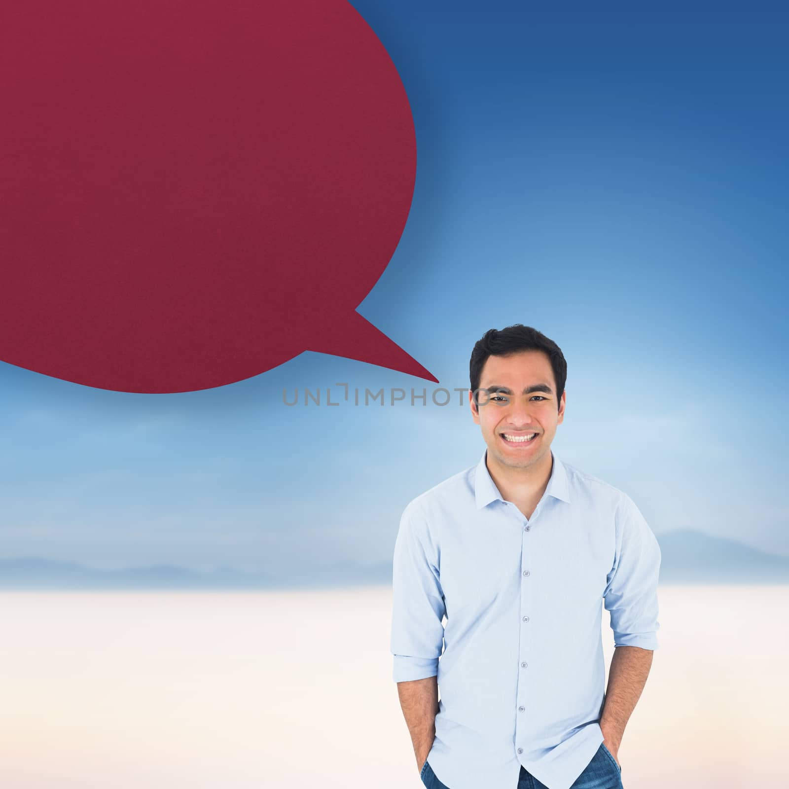 Smiling casual man standing with speech bubble against serene landscape