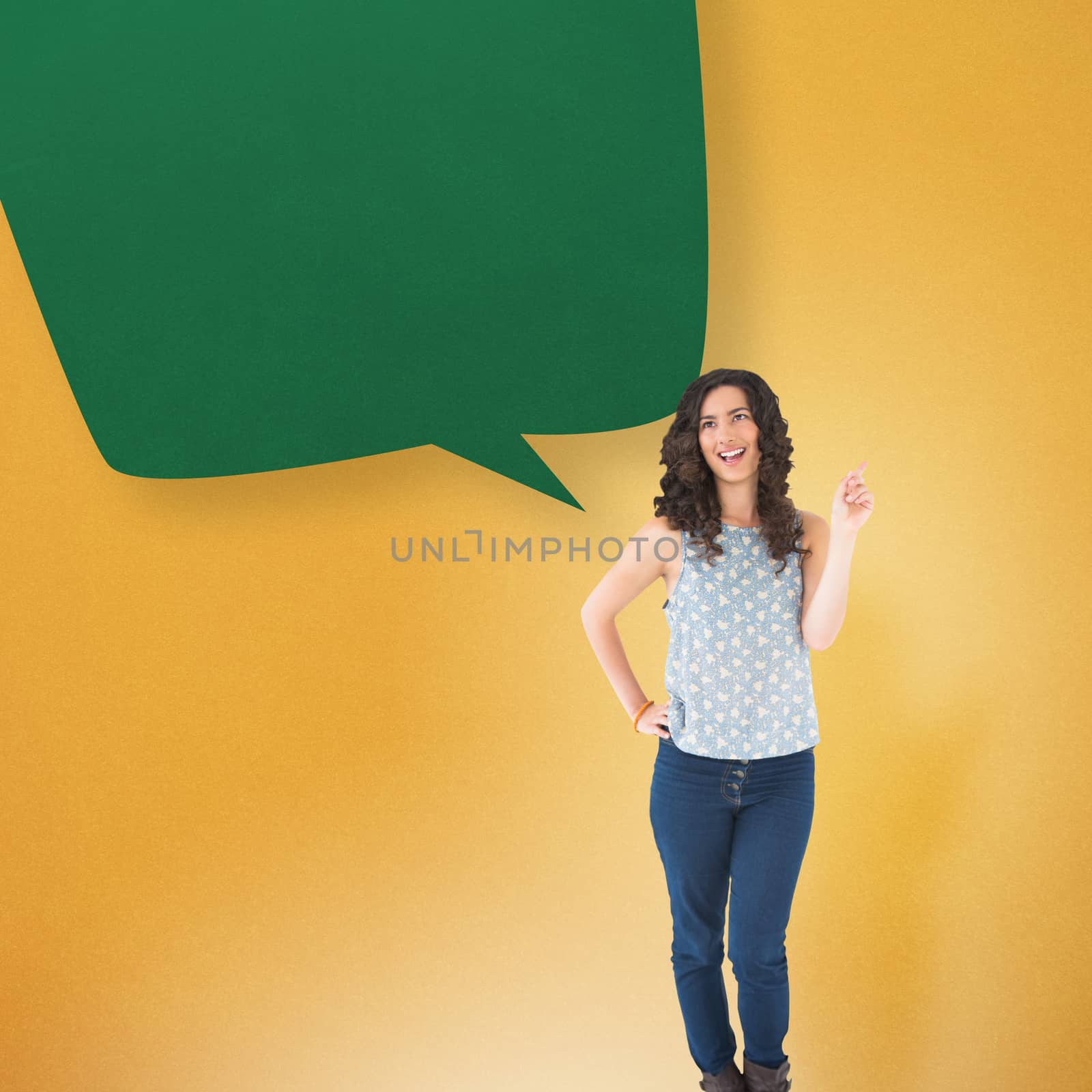 Happy beautiful brunette posing with speech bubble against yellow background with vignette