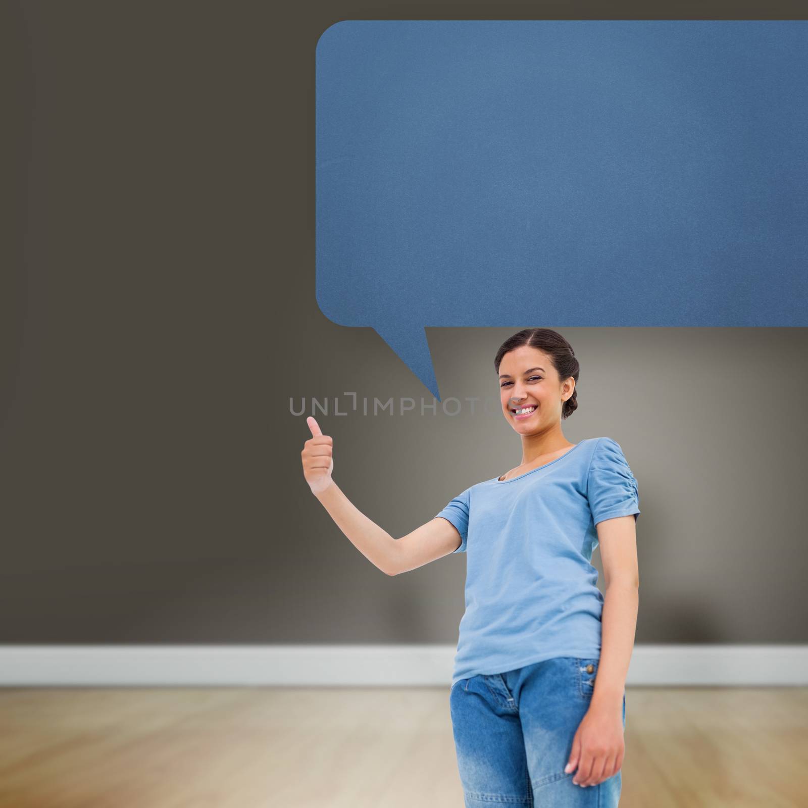 Pretty brunette giving thumbs up against speech bubble