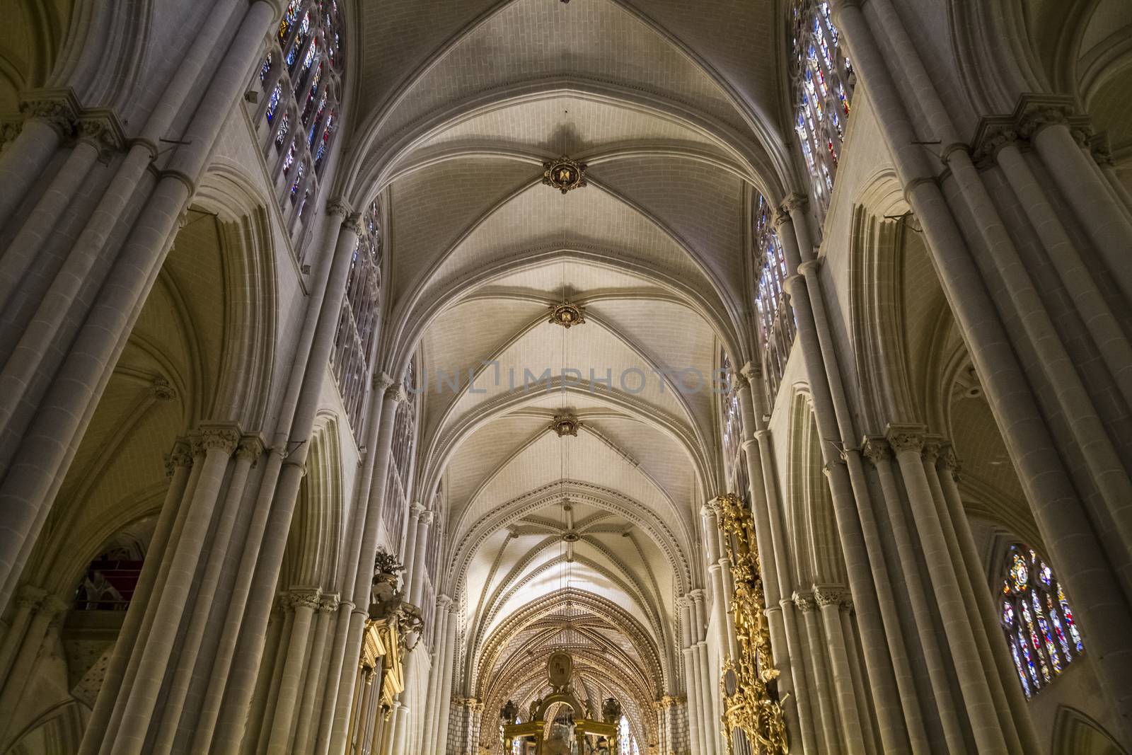 Interior of Toledo Cathedral. Arcs, organ, columns and gothic art. Spain