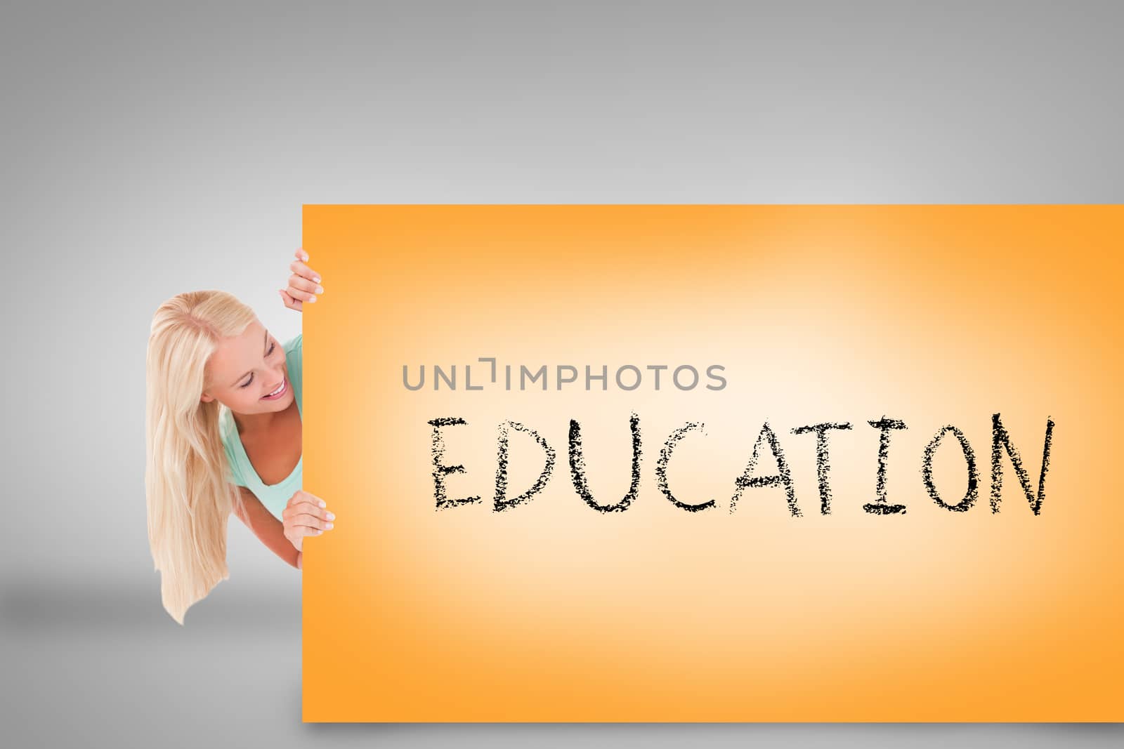 Pretty blonde showing card with education by Wavebreakmedia