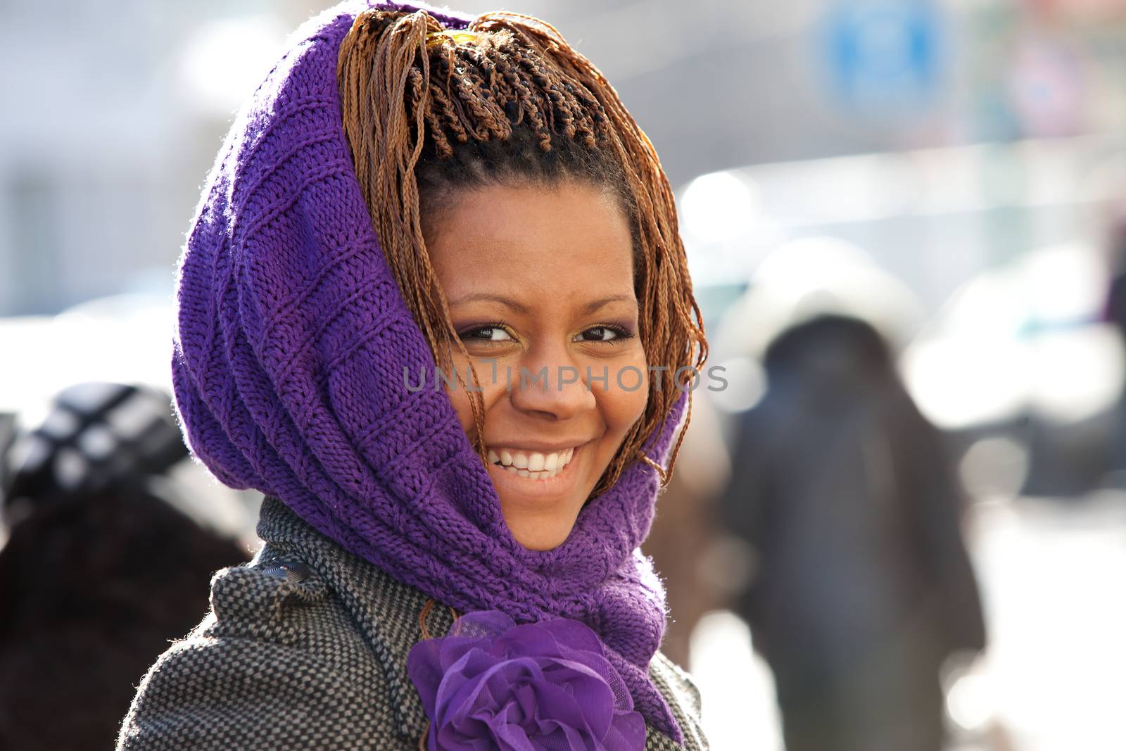 portrait of a laughing girl in a purple scarf