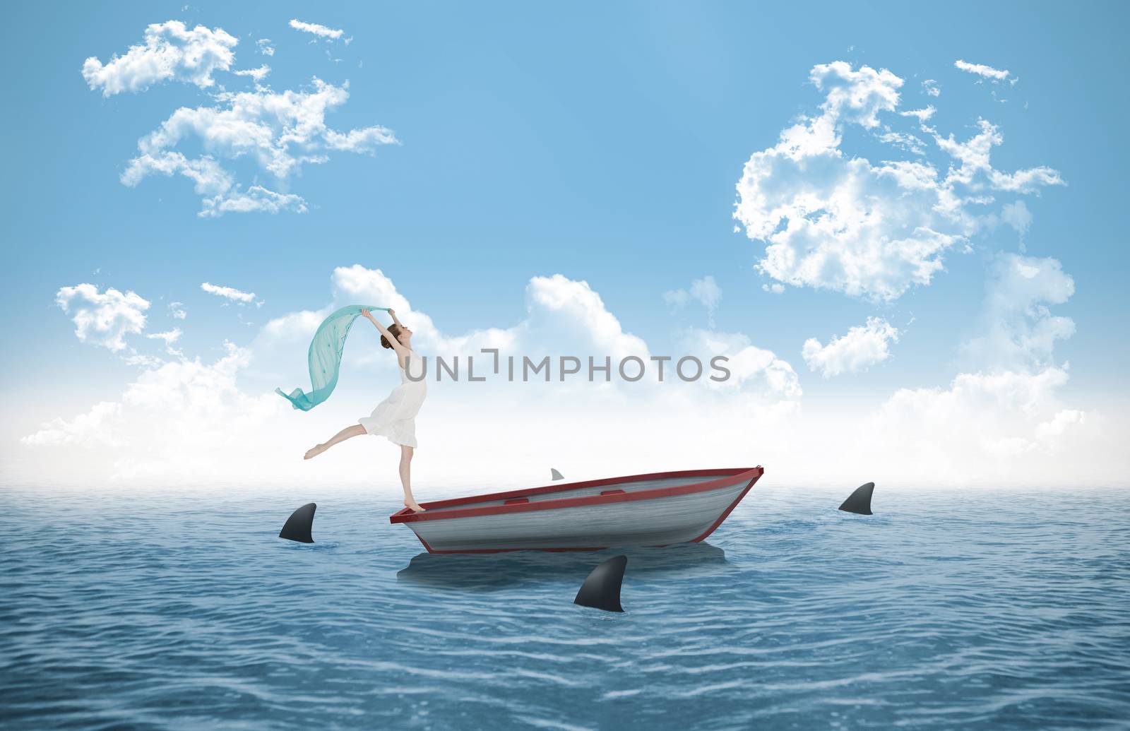 Young beautiful female dancer with blue scarf against sharks circling small boat in the ocean