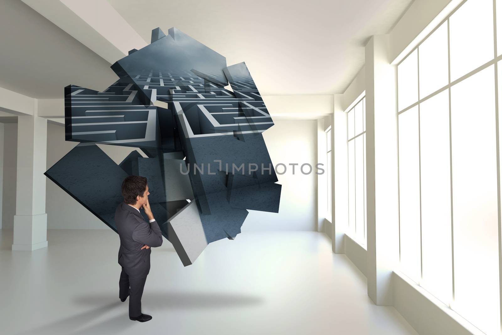 Thinking businessman touching his chin against maze graphic on abstract screen in room