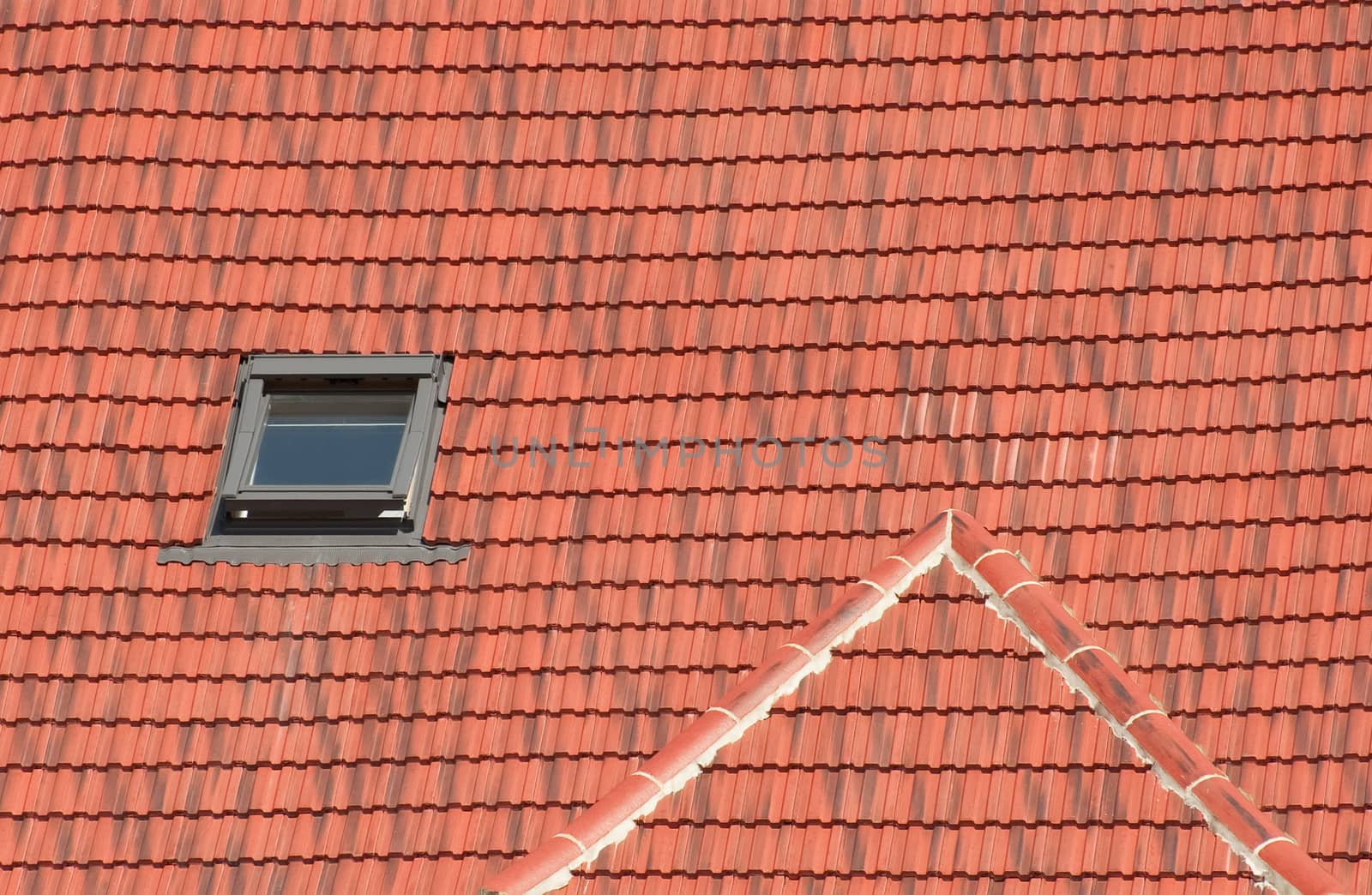 open attic window on a red clay tiled roof