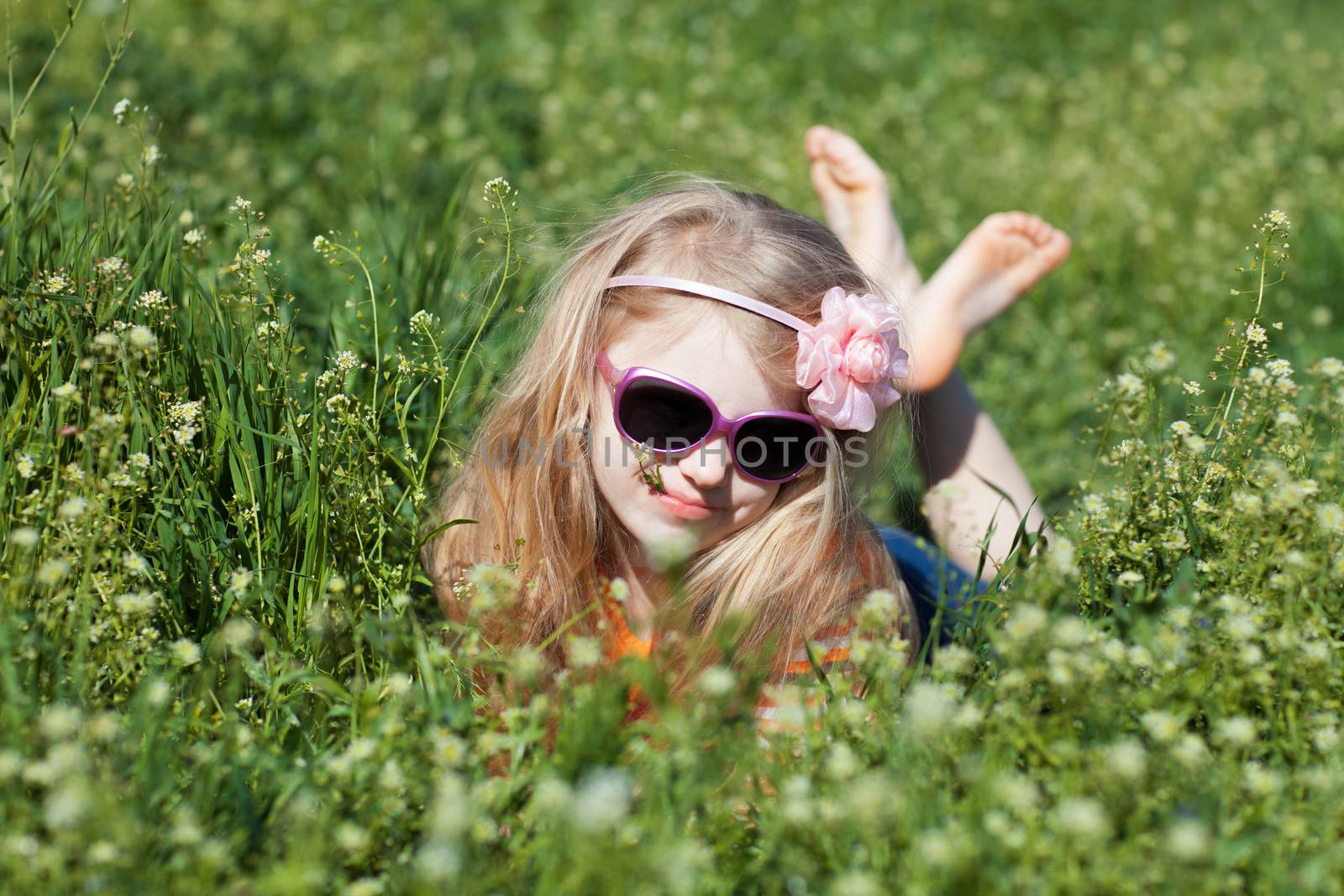 small barefooted girl in grass by vsurkov