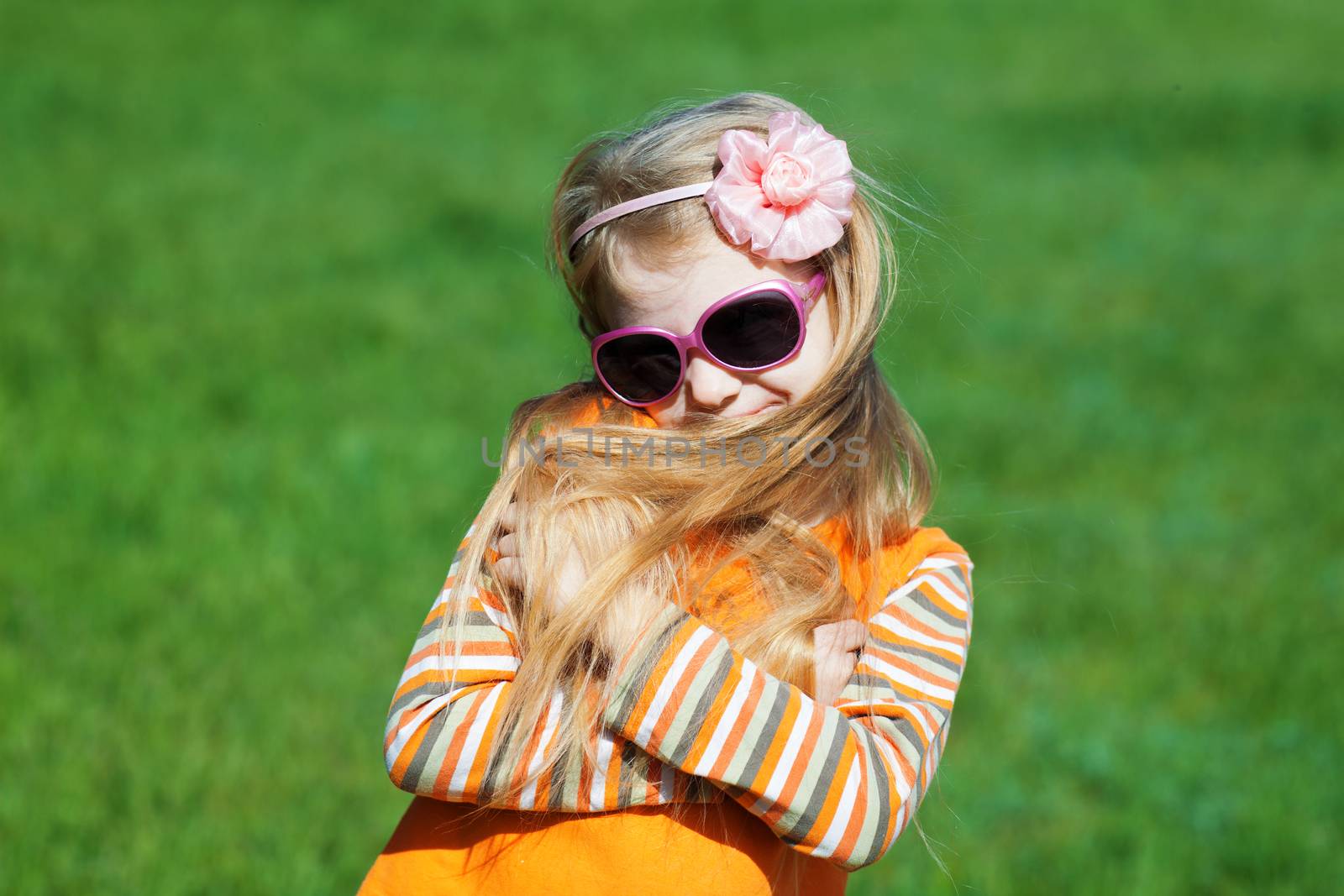 shy fashion girl with long hair outdoors