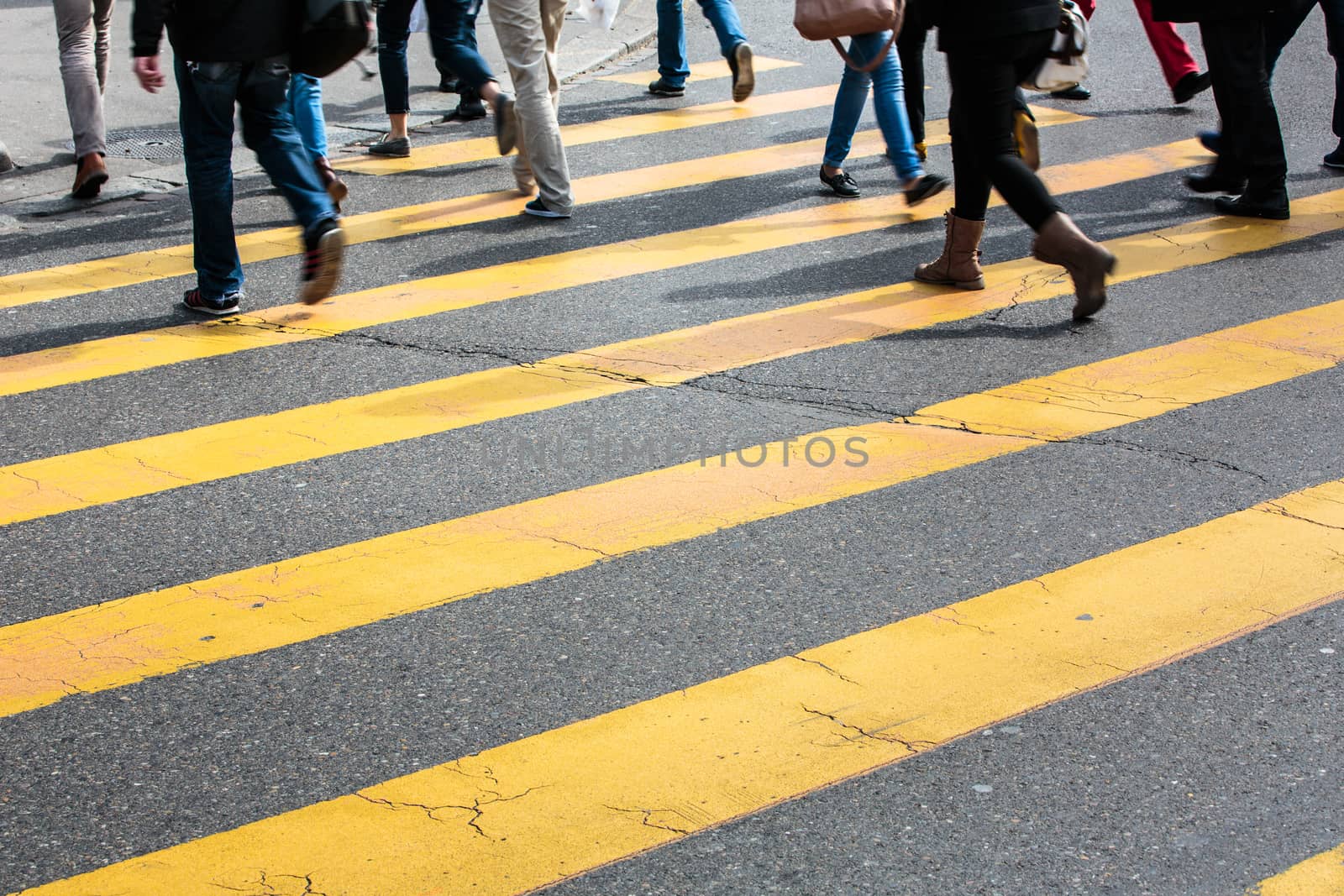 urban traffic concept - city street with a motion blurred crowd crossing a road