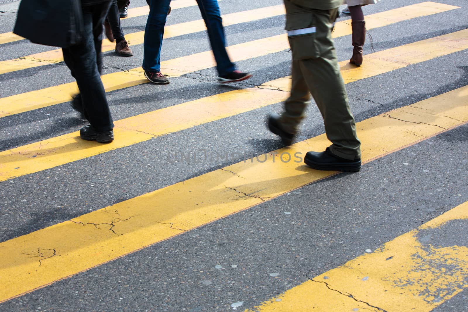 urban traffic concept - city street with a motion blurred crowd crossing a road