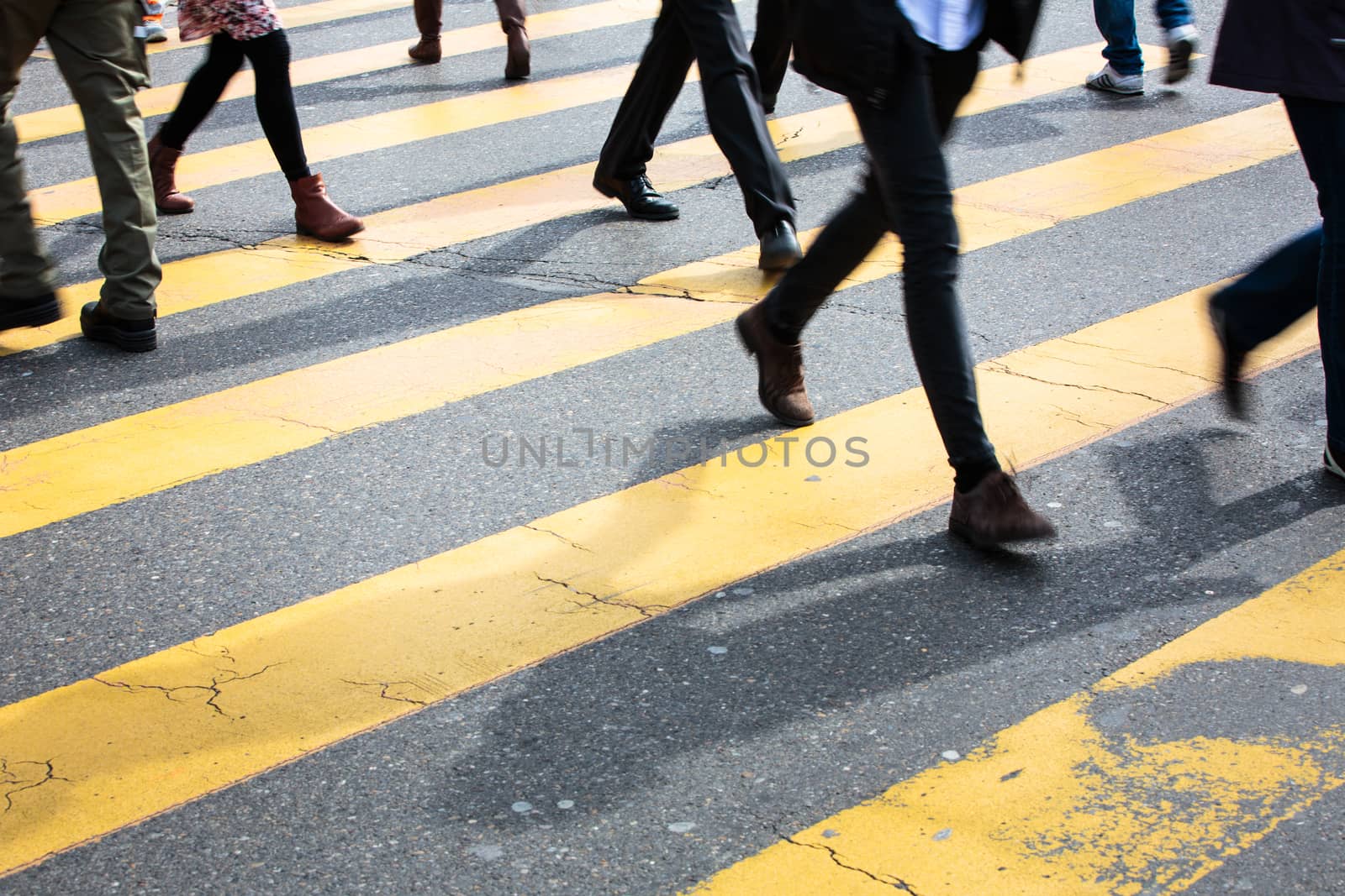 urban traffic concept - city street with a motion blurred crowd crossing a road