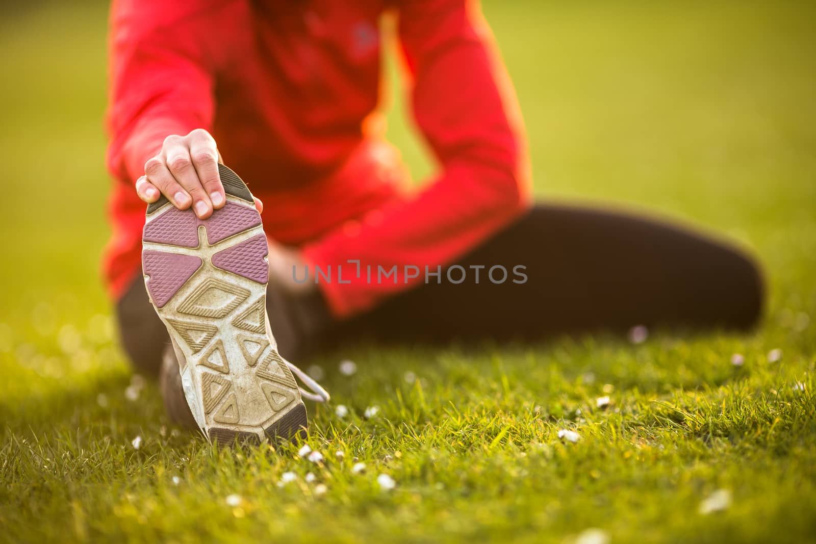 Young woman stretching before her evening run