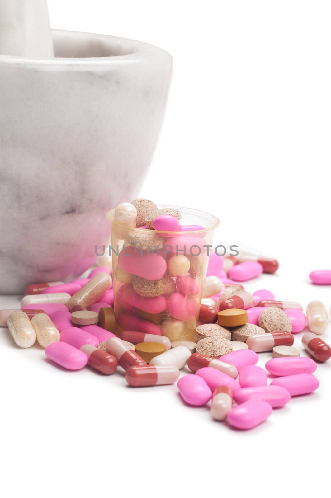 Shot of pink pills with marble mortar grinding machine