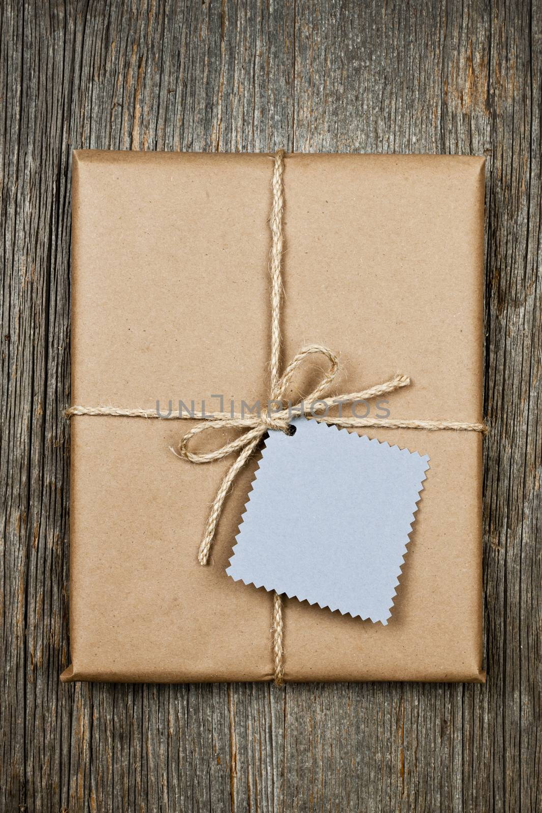 Gift with tag in brown paper by elenathewise