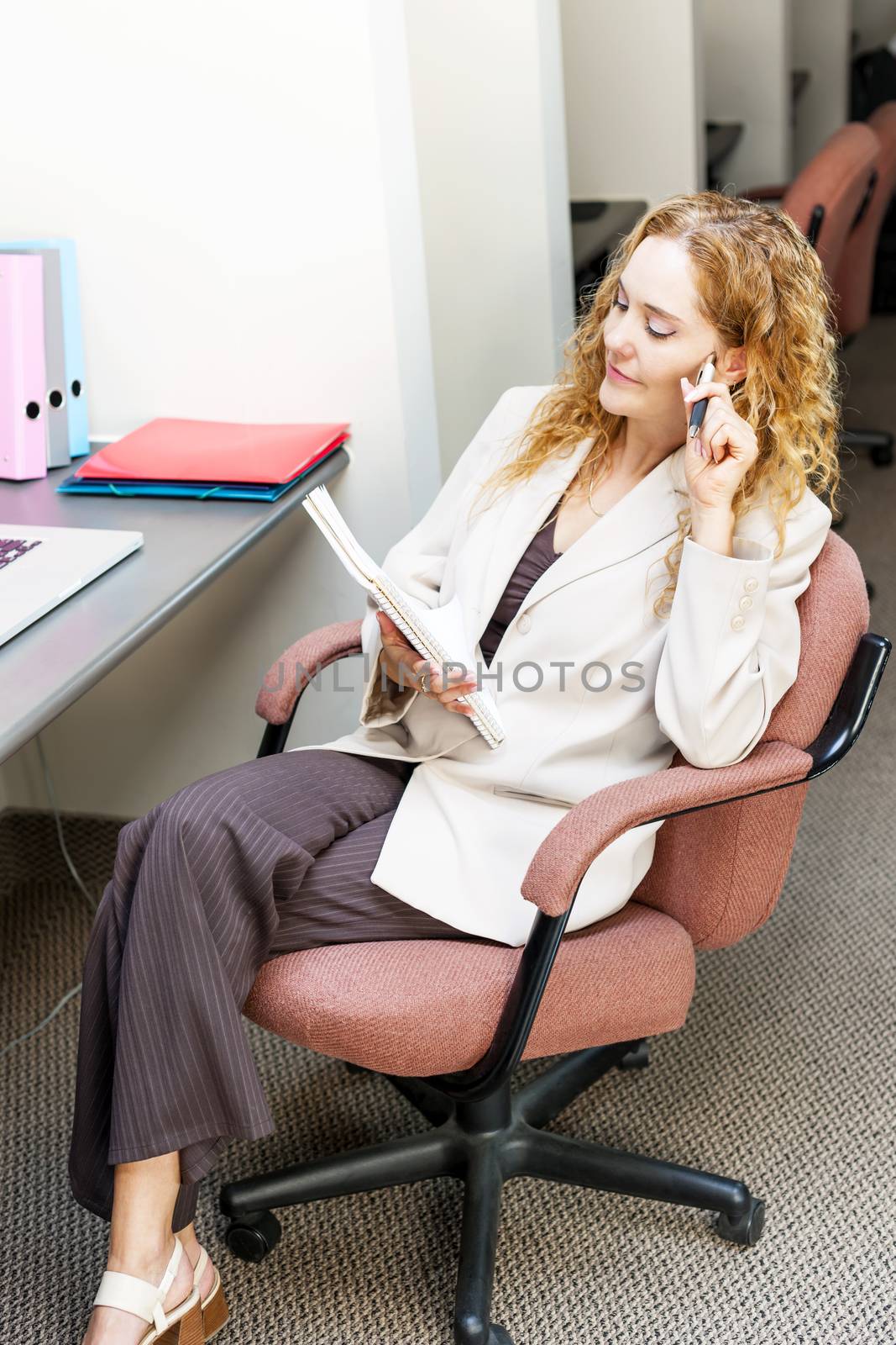 Business woman thinking at office desk by elenathewise