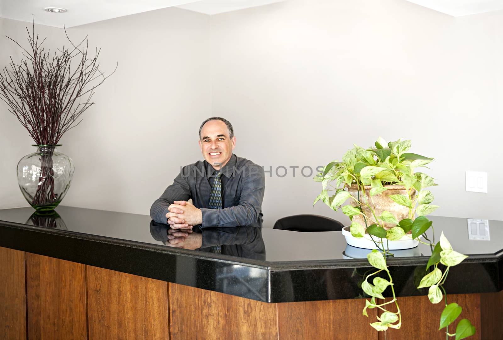 Businessman standing at reception counter in office