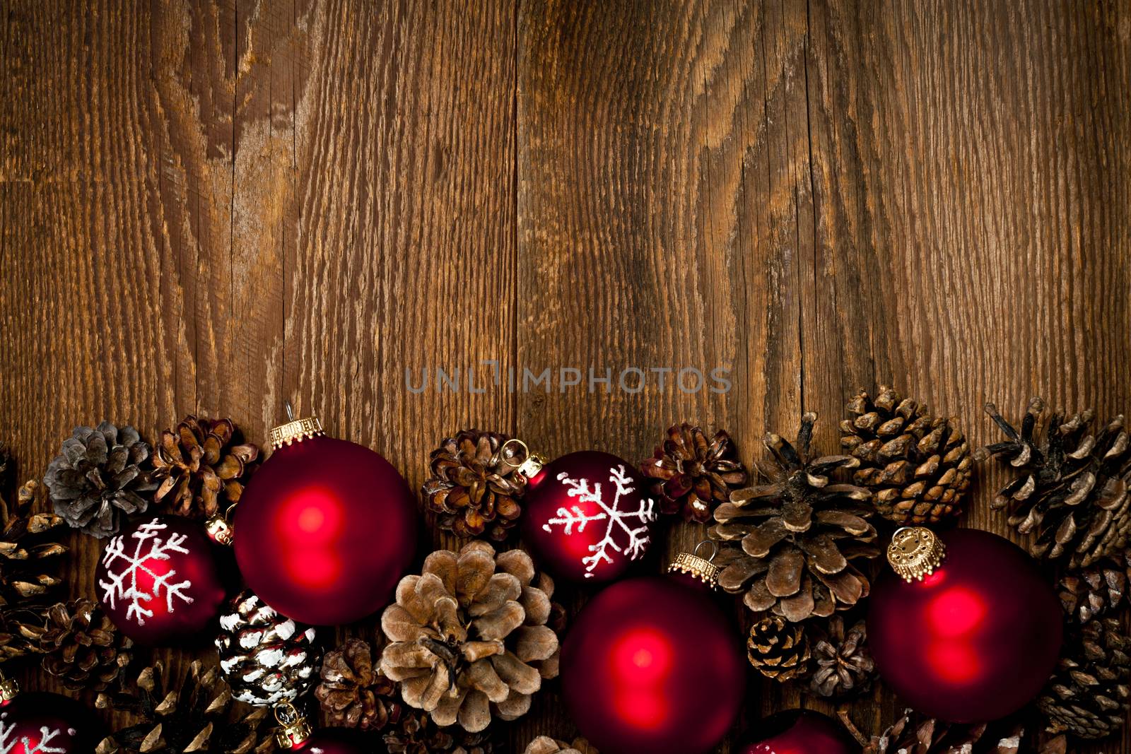 Rustic wood background with Christmas ornaments and pine cones