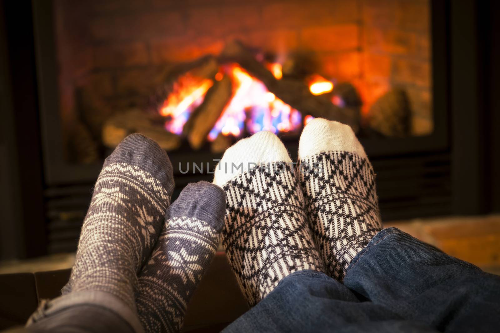 Feet warming by fireplace by elenathewise