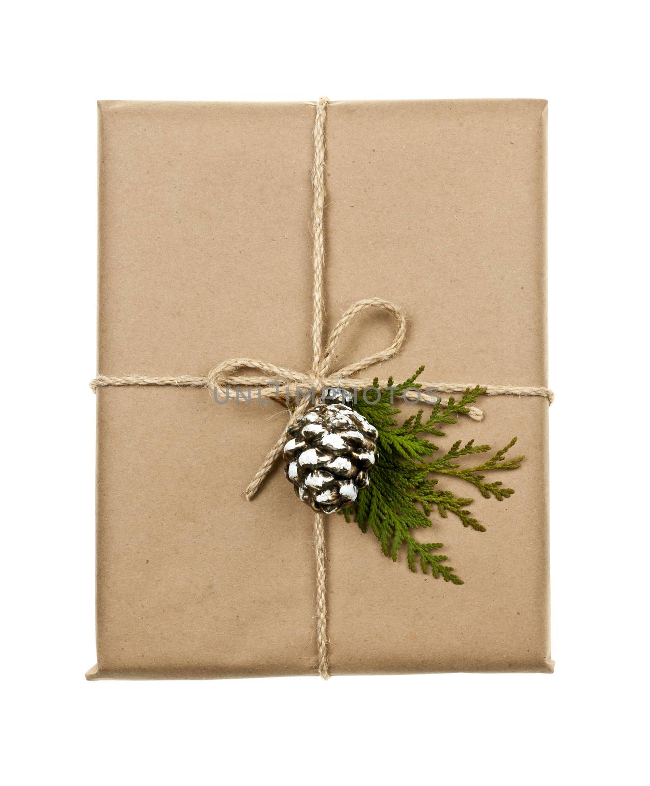 Christmas gift in brown wrapping and string with pine cone decoration isolated on white