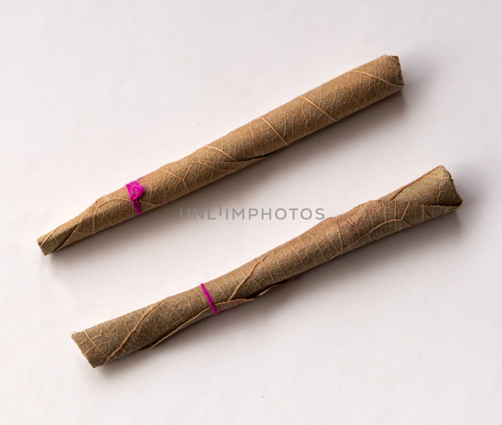 Two of the Cheap Indian Beedi Cigarette. by Claudine