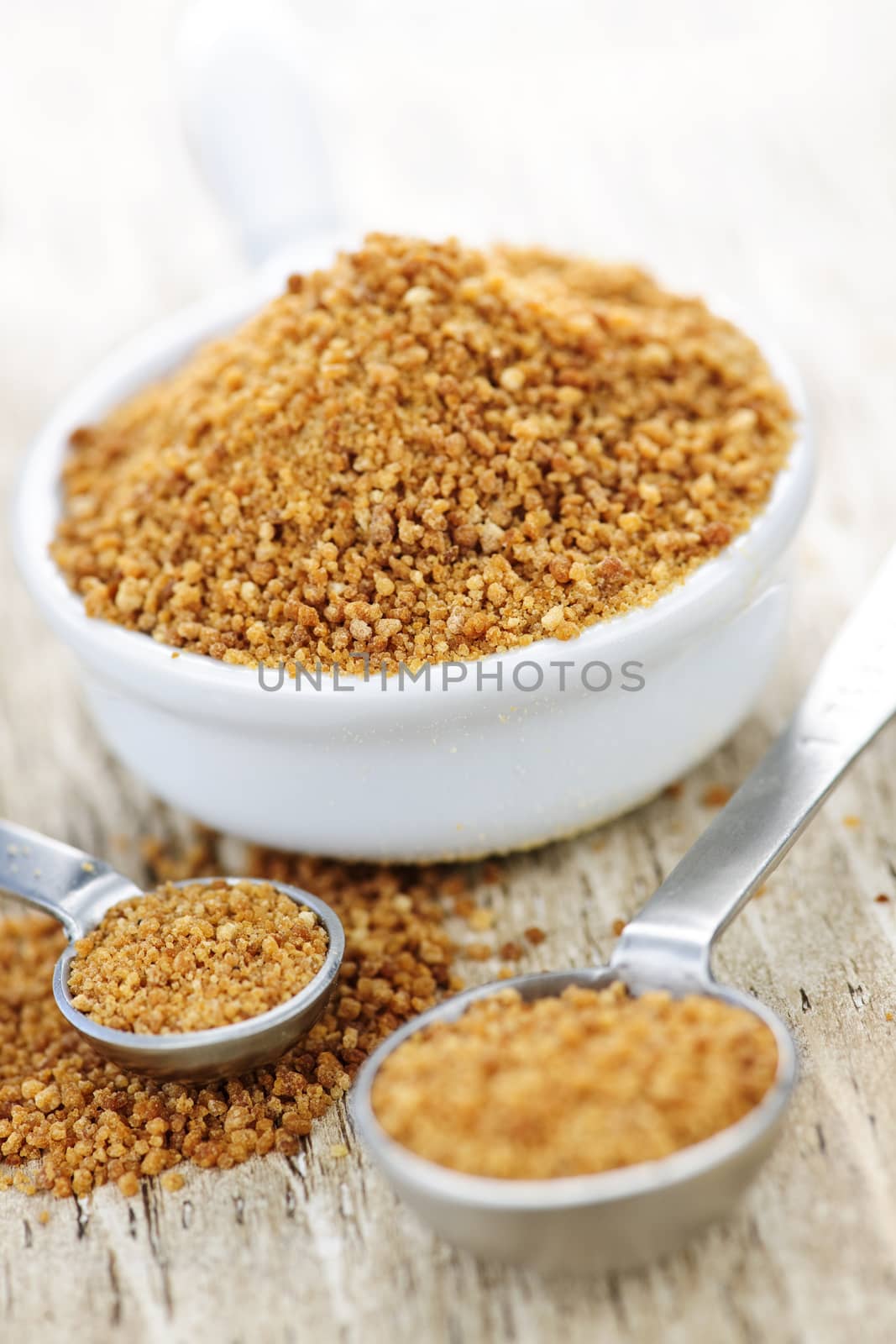 Organic coconut palm sugar in measuring spoons