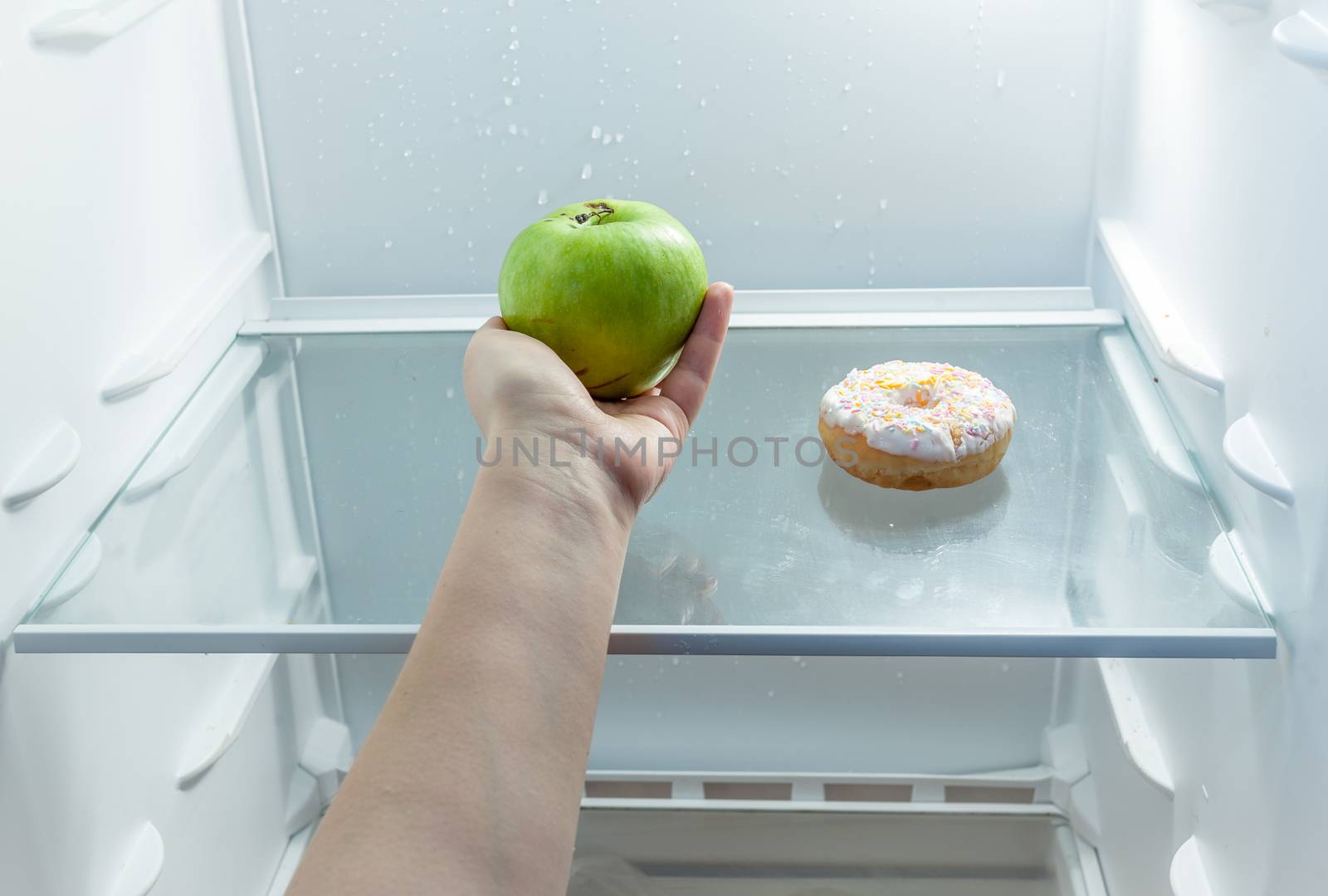 Conceptual photo of woman choosing fruits instead of cake
