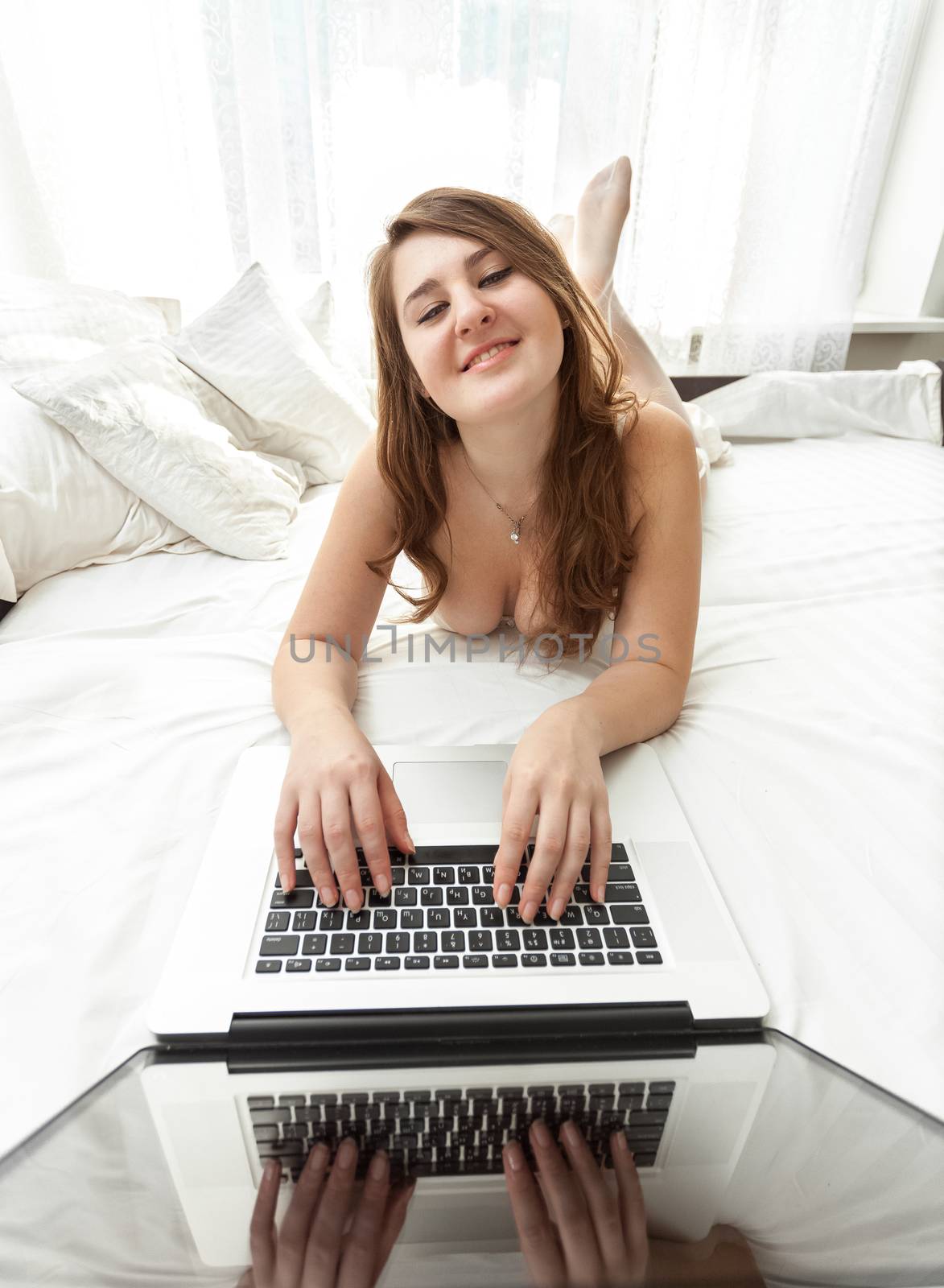 sexy woman with laptop in bed by Kryzhov