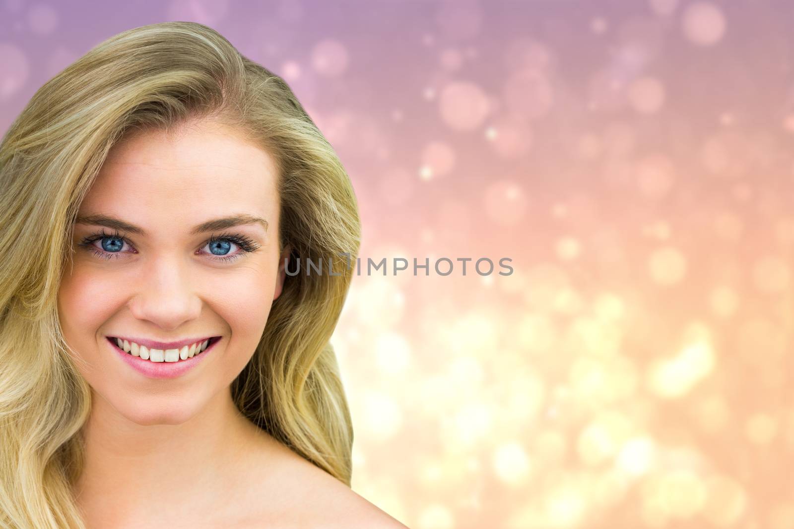 Smiling blonde natural beauty against pink abstract light spot design